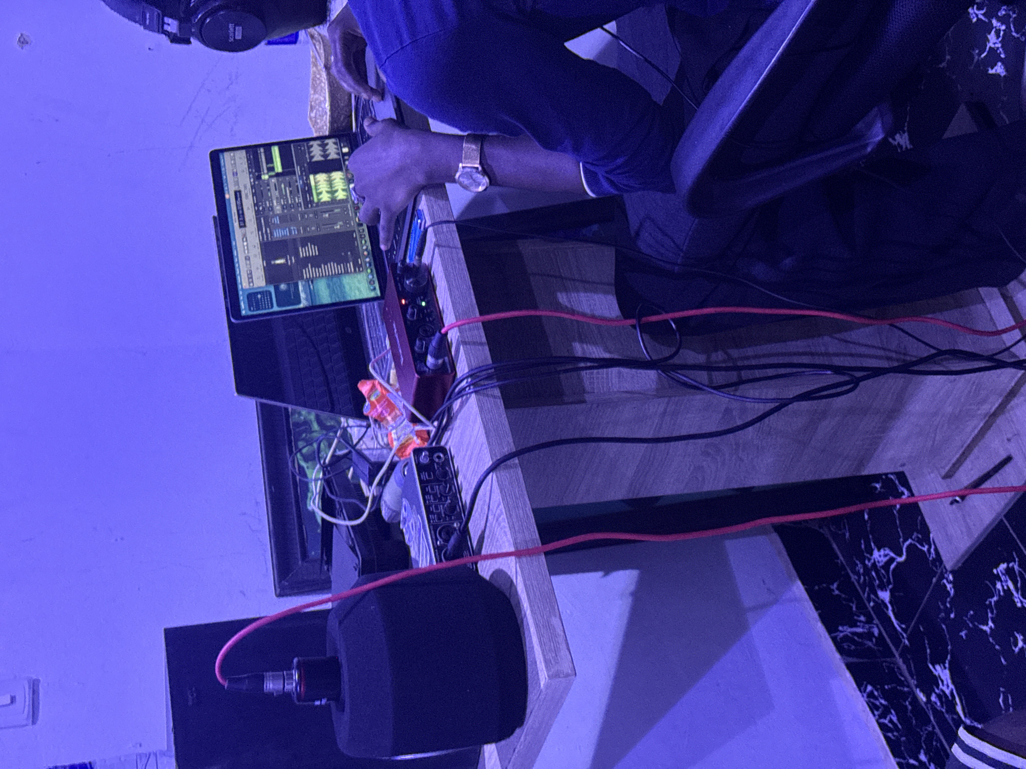 Late-night recording session captured in blue-lit Abuja studio