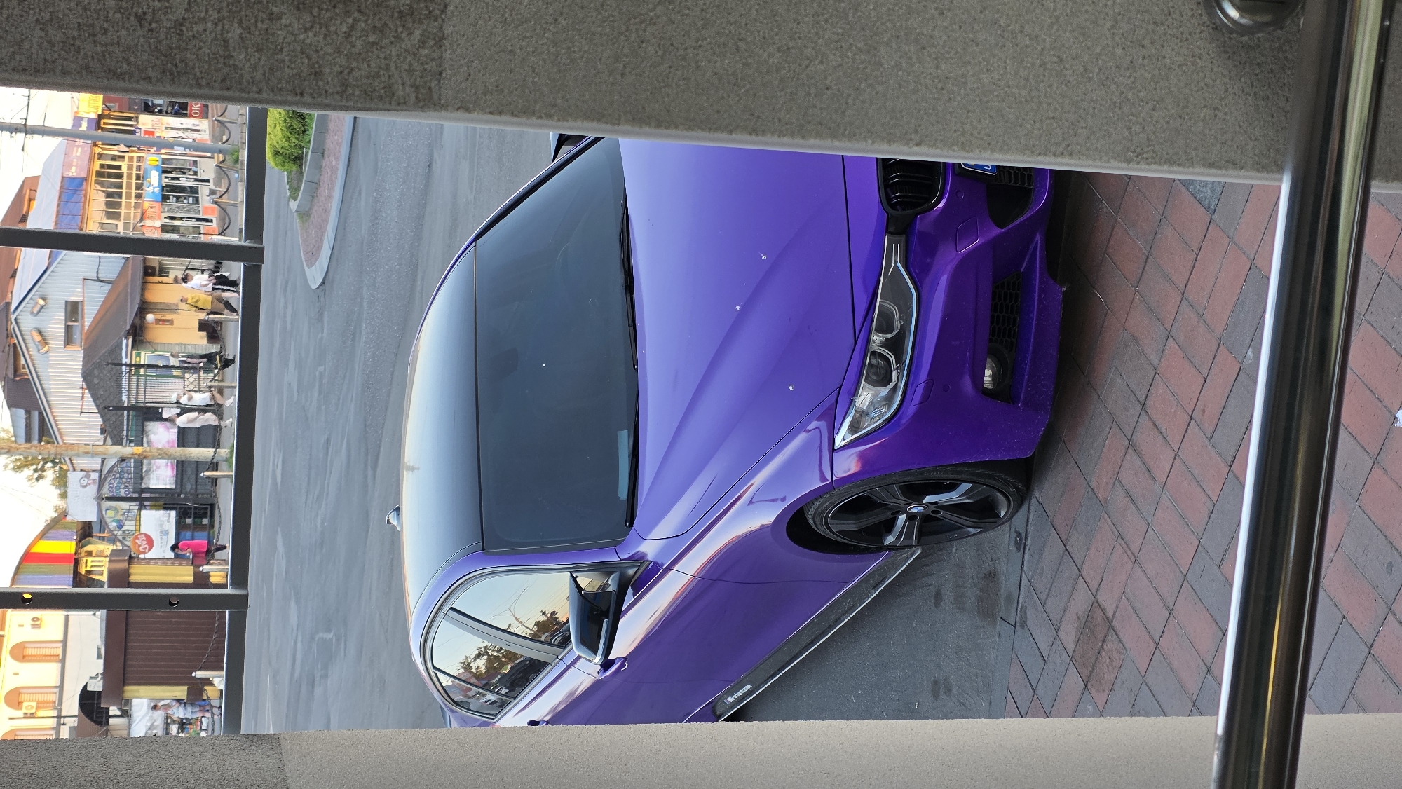 Purple BMW parked on brick plaza in Vinnytsia