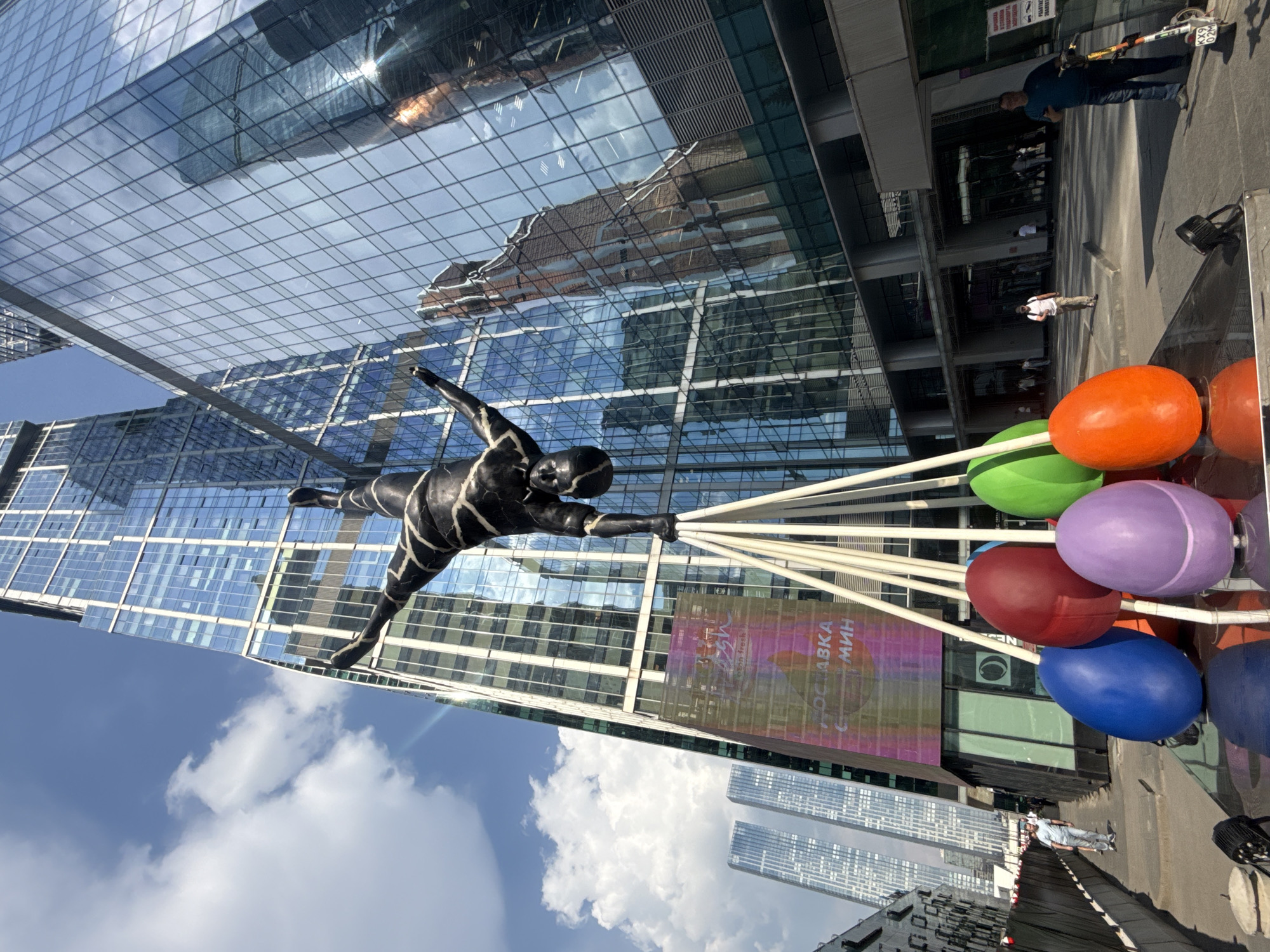 Suspended acrobatic sculpture observed in Moscow public art display