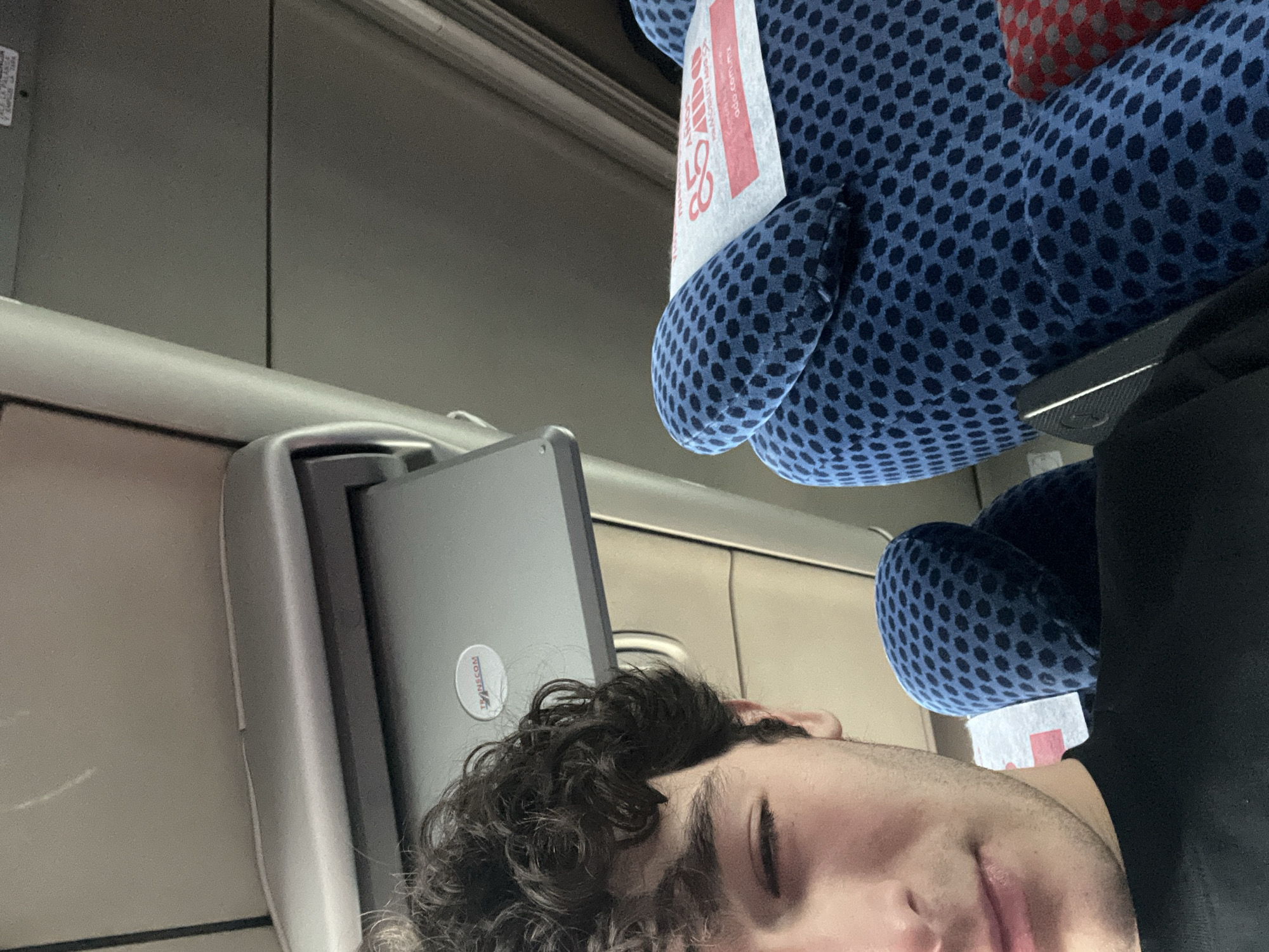 Passenger sleeps with laptop on Mexican bus or train