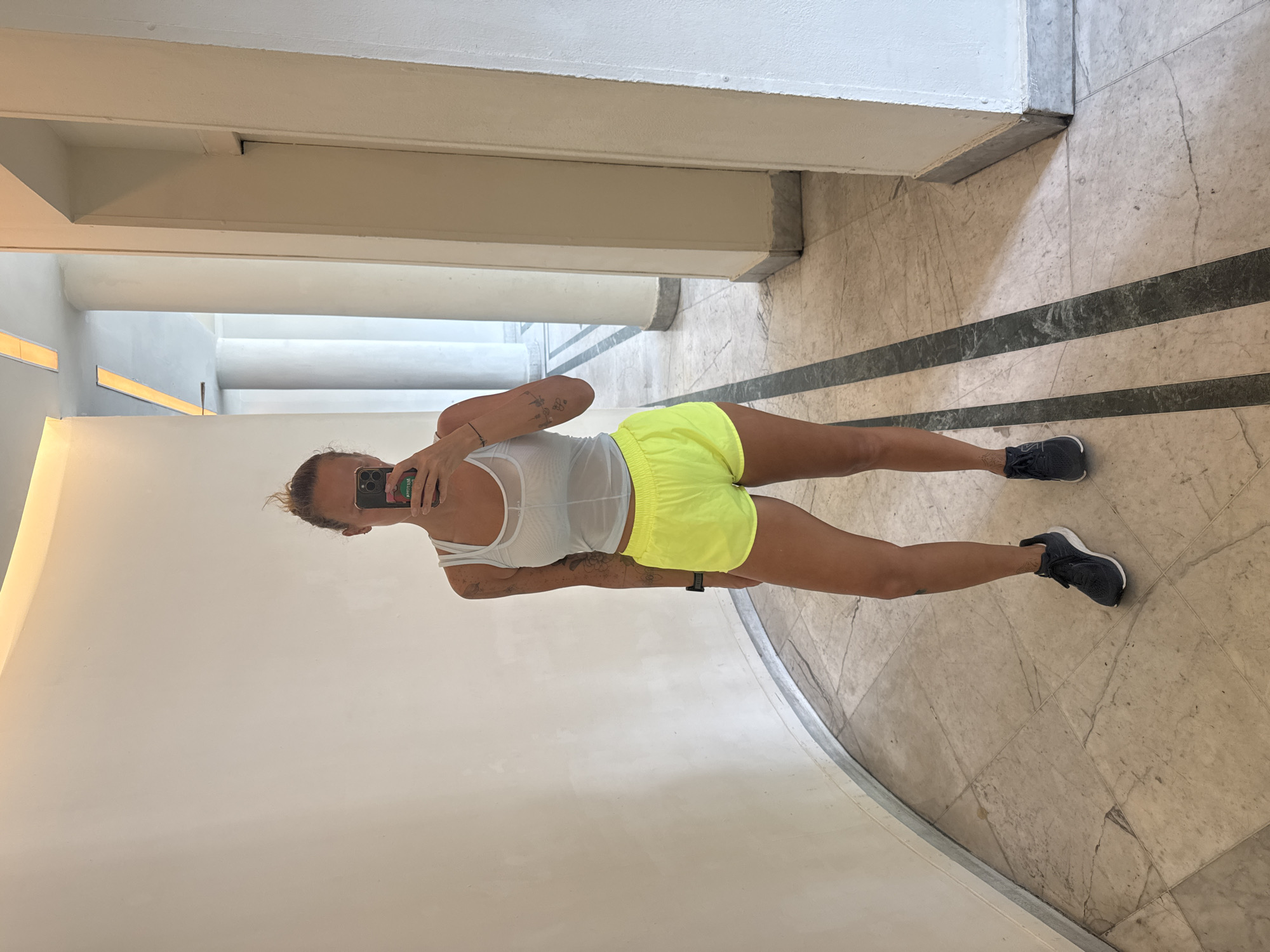Mirror selfie in a curved white hallway, Tel Aviv