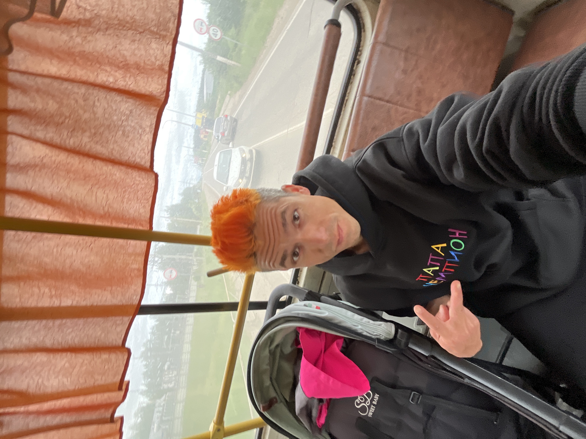 Orange-haired man takes selfie on Chaikovsky public transport