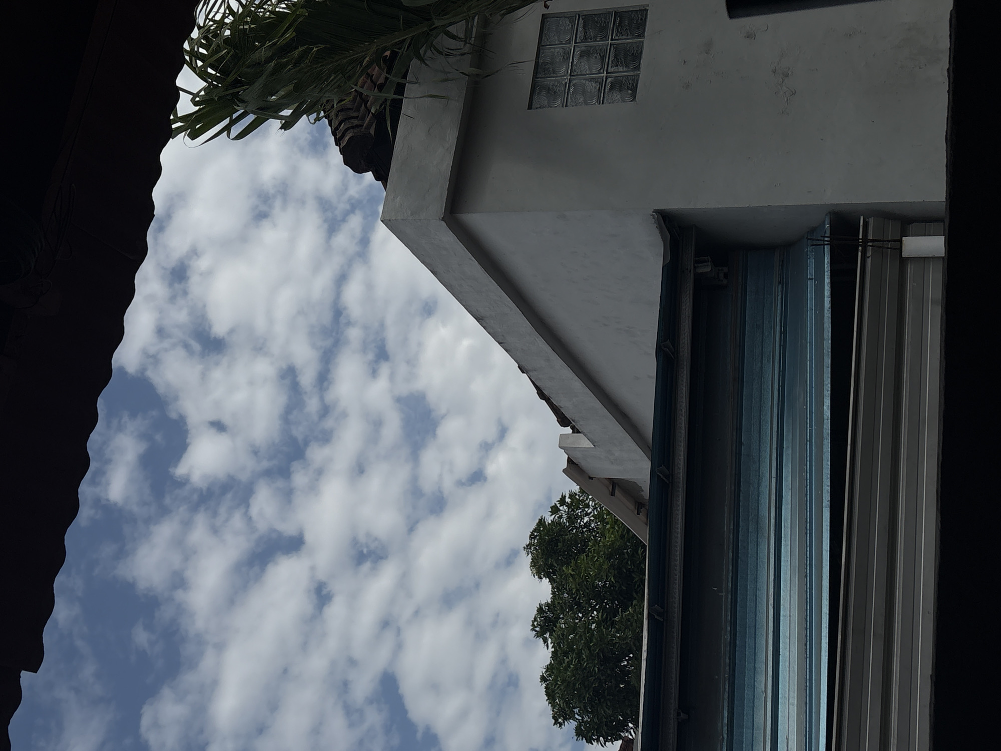 Rooftops and sky over a Denpasar neighborhood
