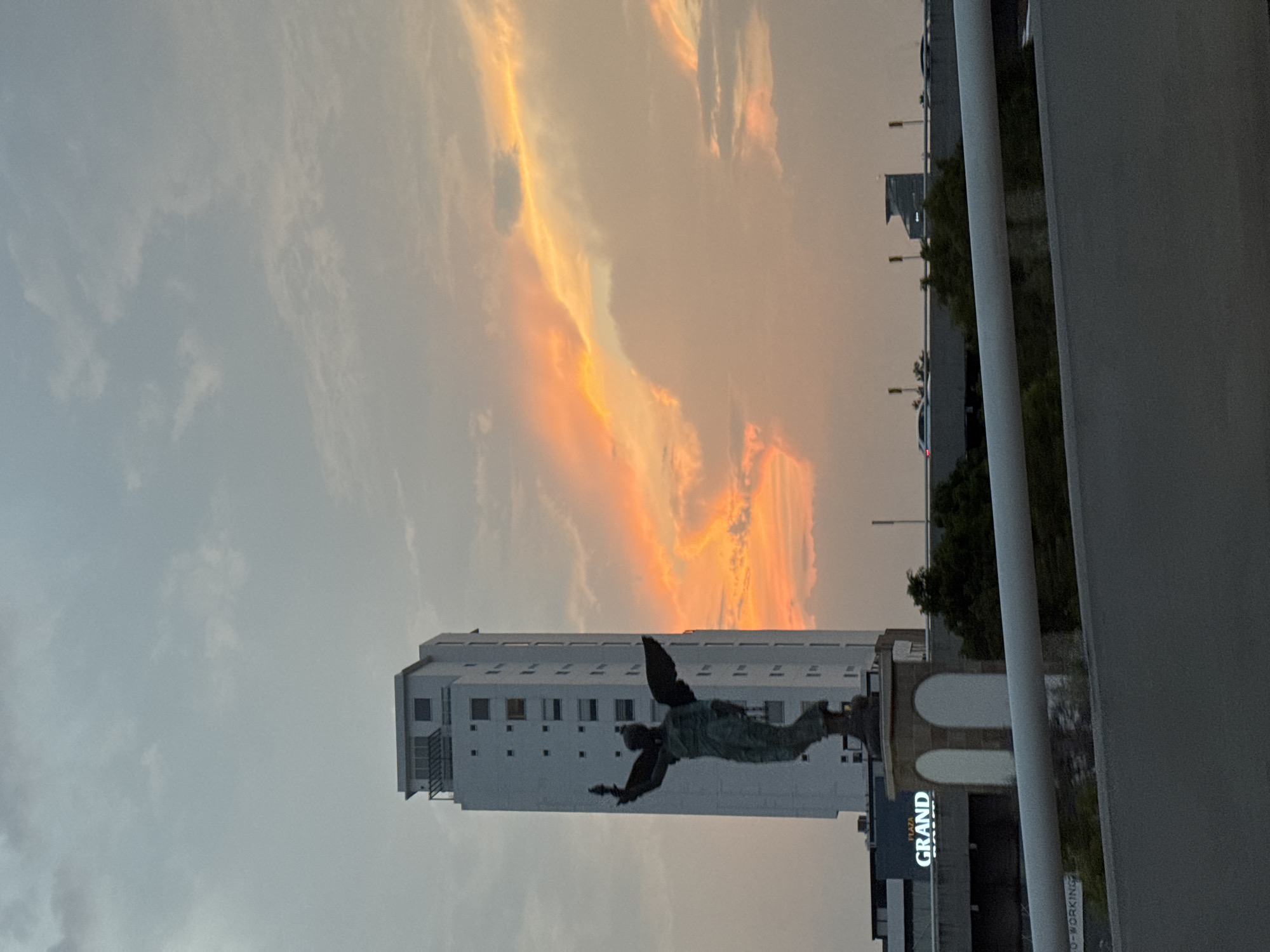 Angel statue captured against colorful sky in Puebla