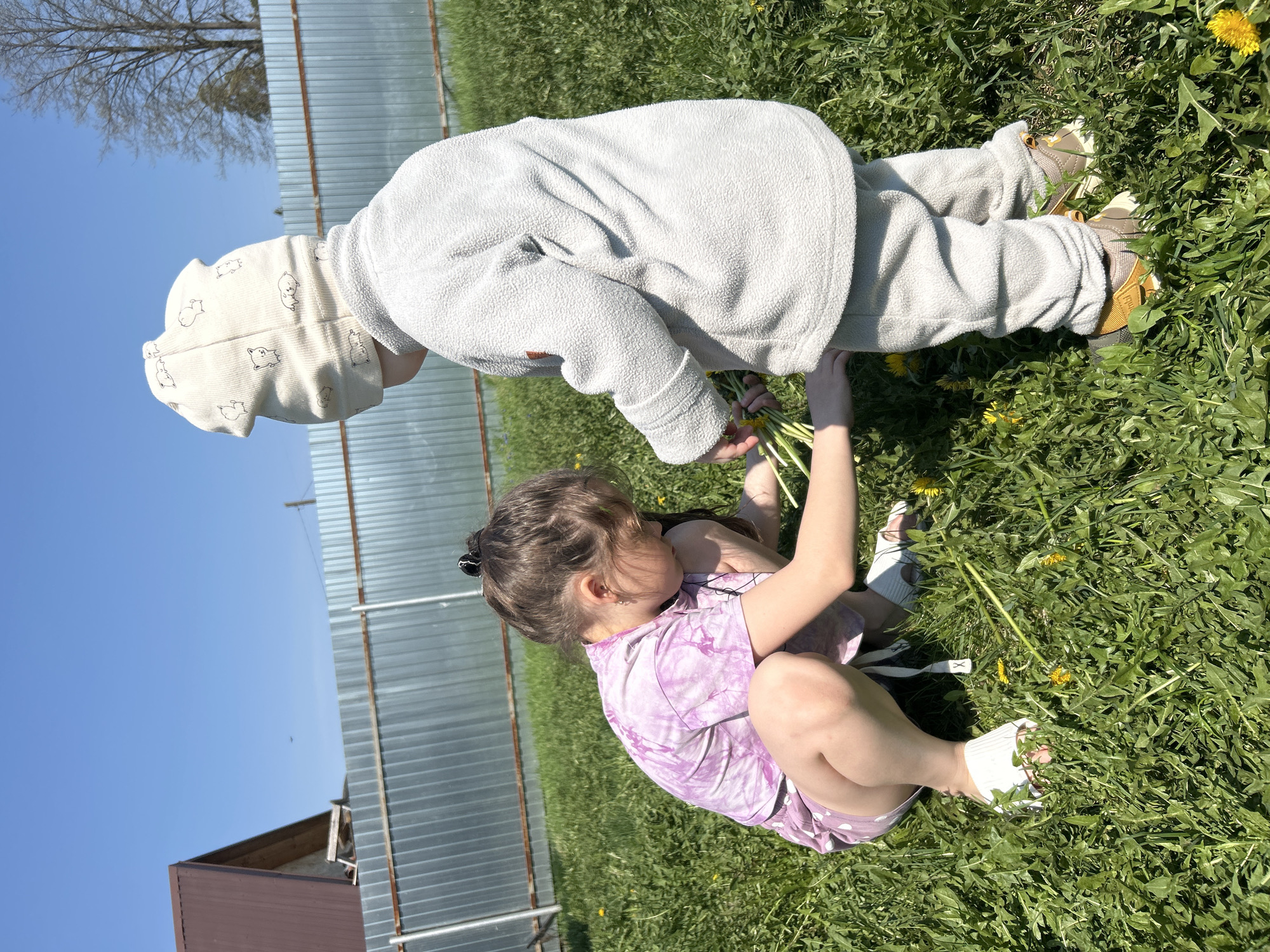 Children play with dandelions in Chaikovsky park