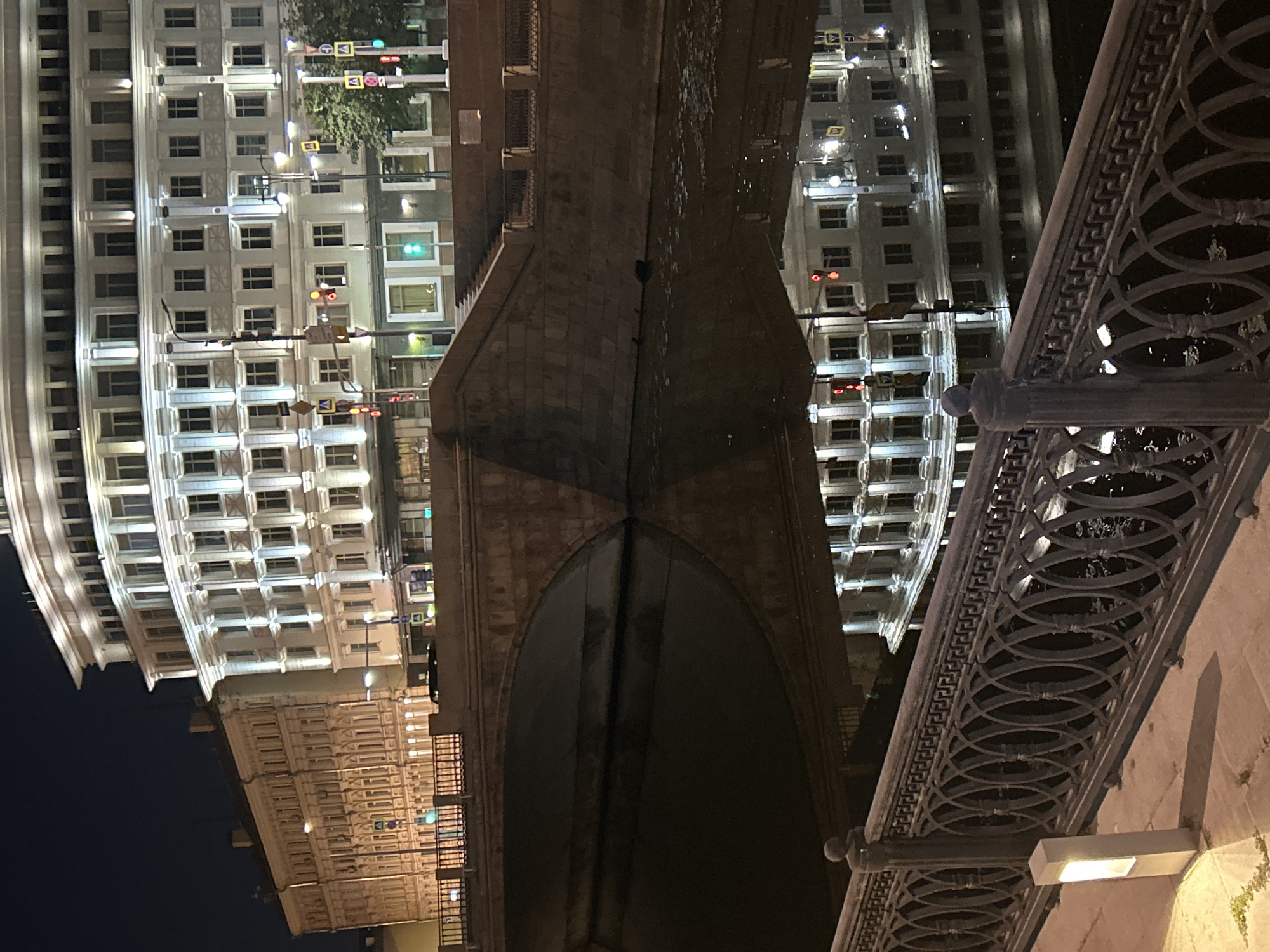 Ornate riverside building and surroundings at night