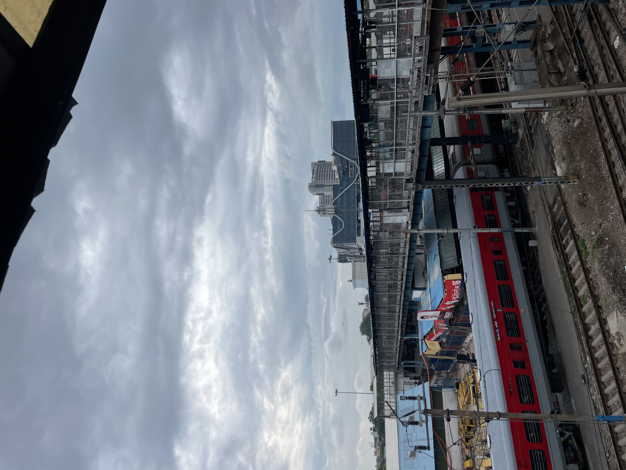 Inside a busy New Delhi railway station on a cloudy morning