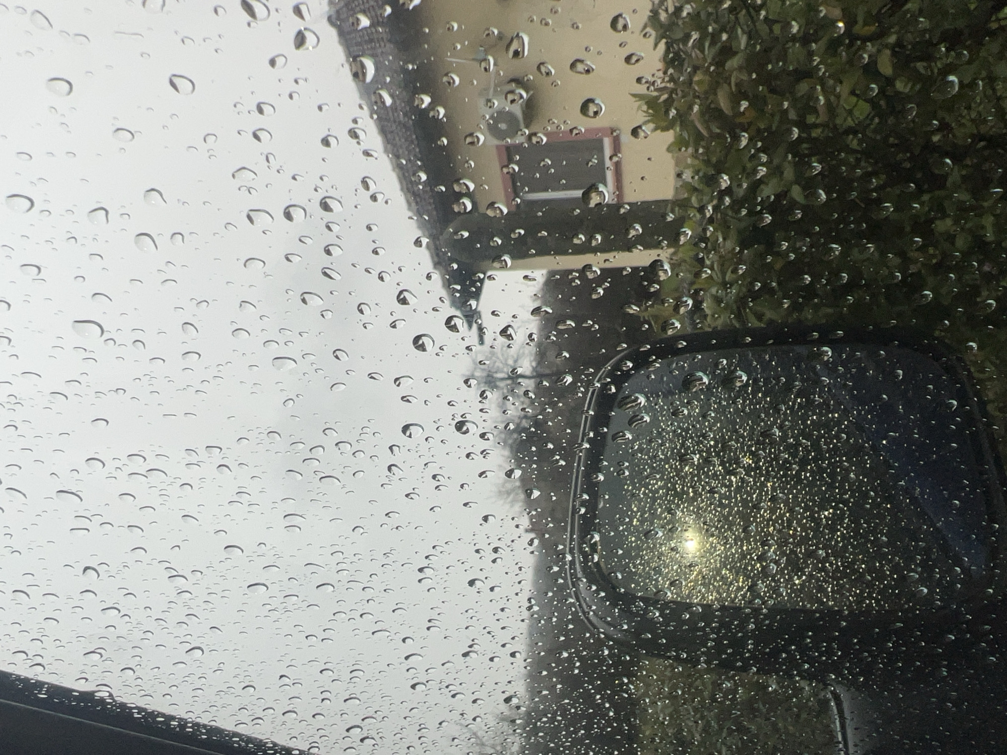 Rain-streaked windshield view captured during drive in Shumata, Bulgaria