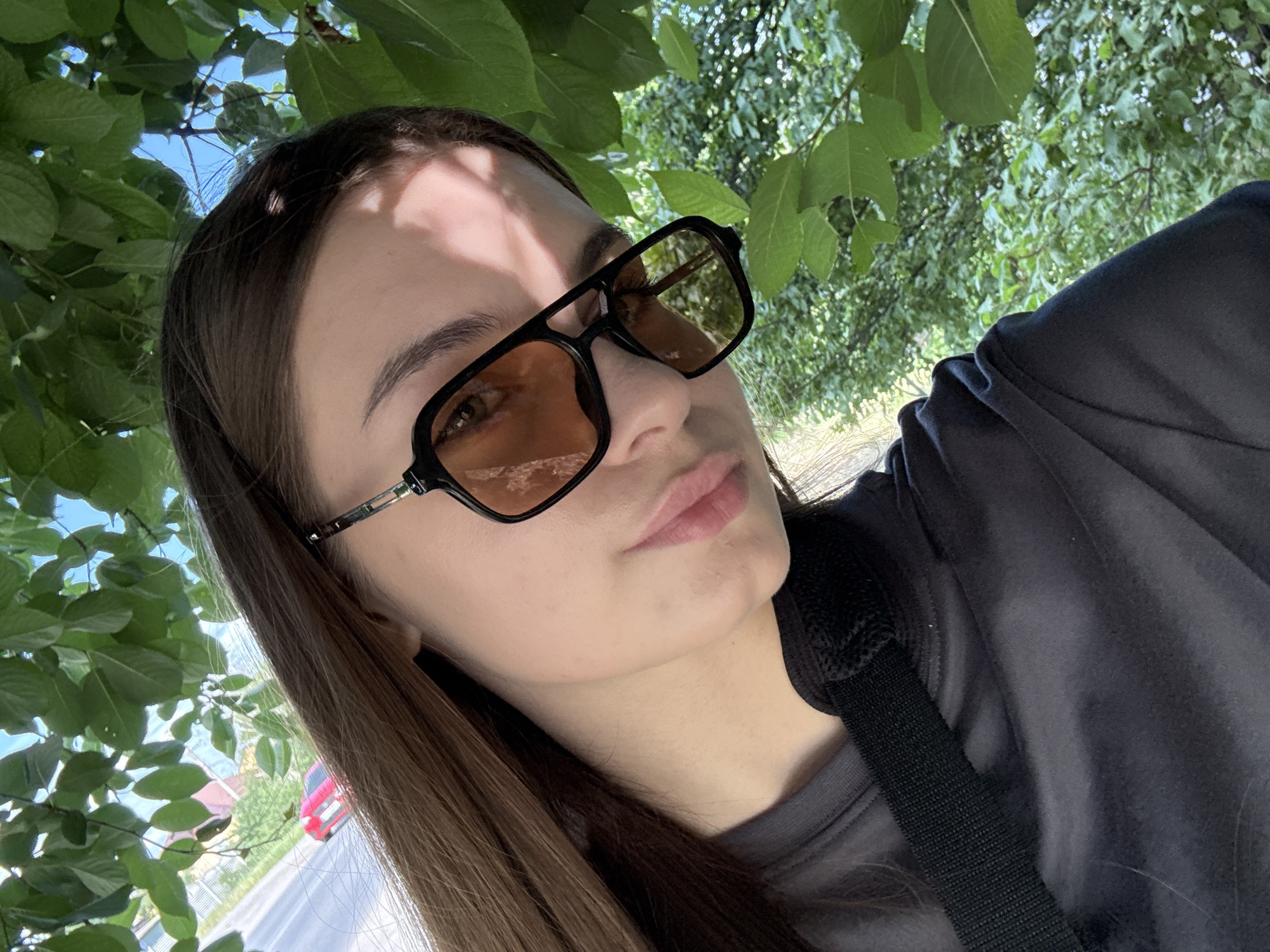 Woman documents sunny afternoon walk through blooming Dnipro neighborhoods