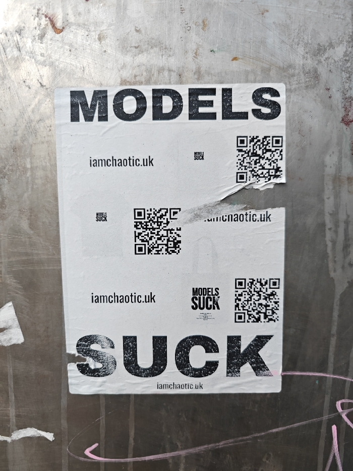 White poster spotted on grey urban surface in London