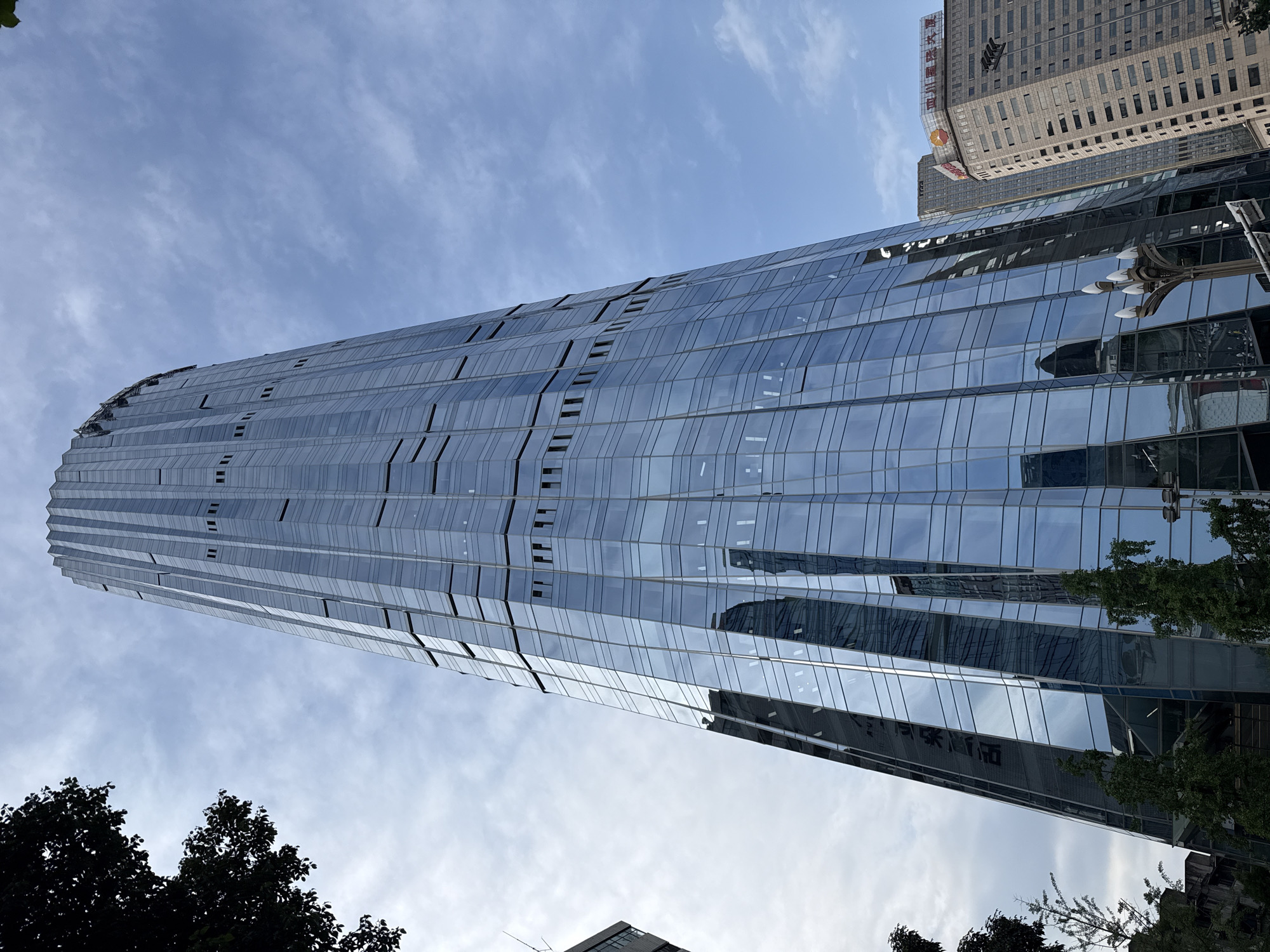 Modern tiered glass skyscraper observed in Jinjiang District, China