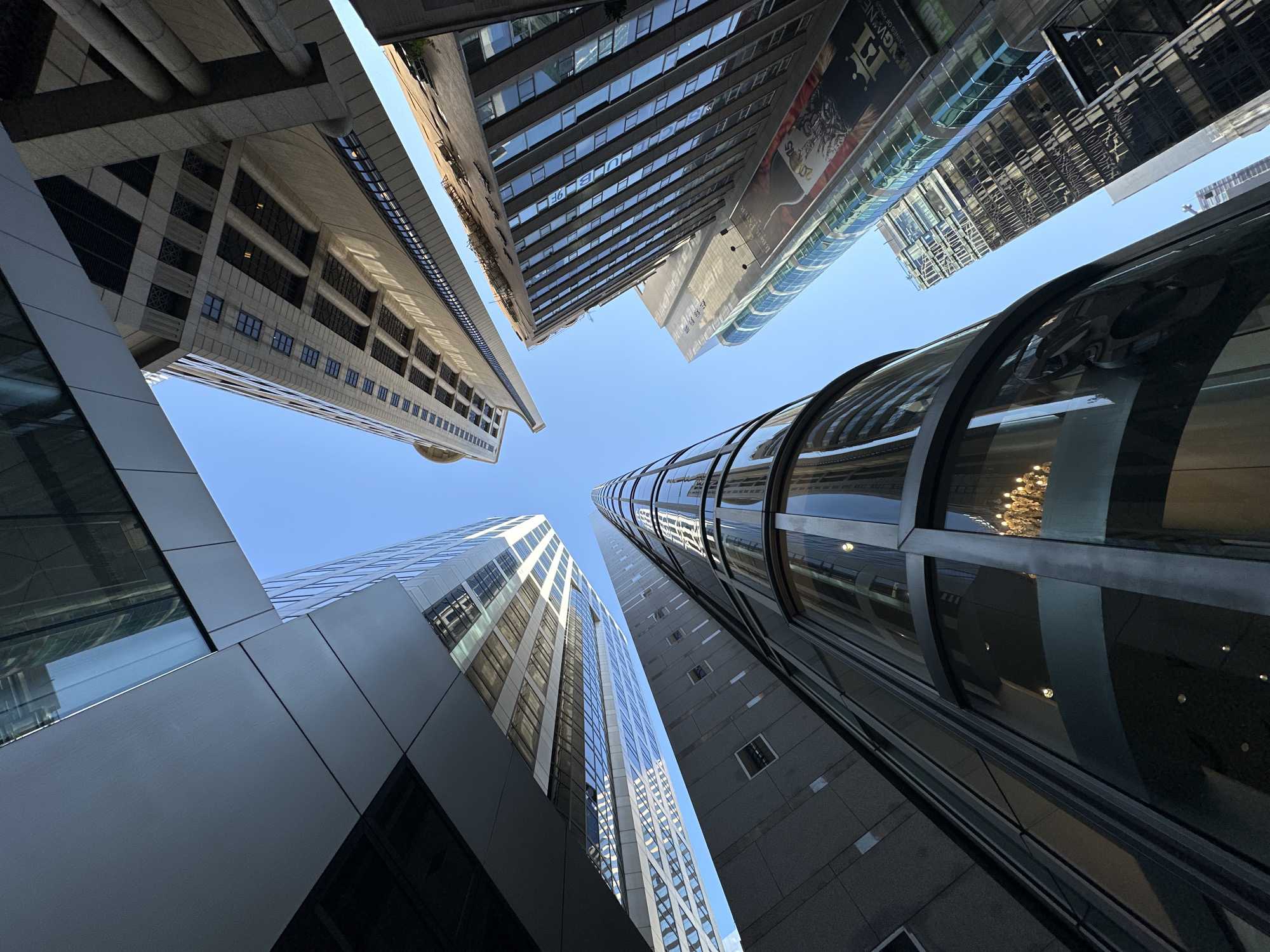 Looking up at Hong Kong's glass towers on a clear day