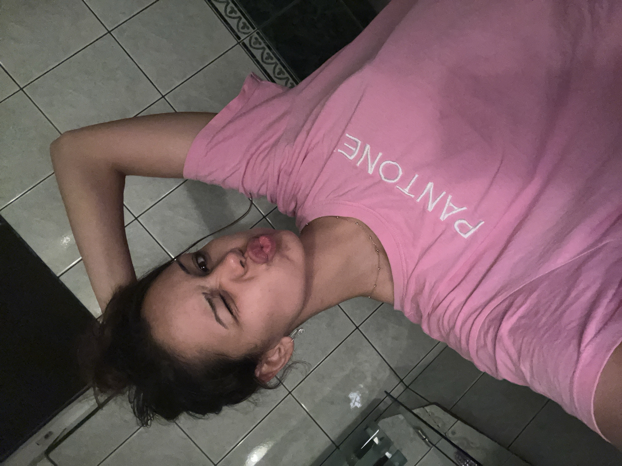 Young woman takes playful selfies during nighttime outing