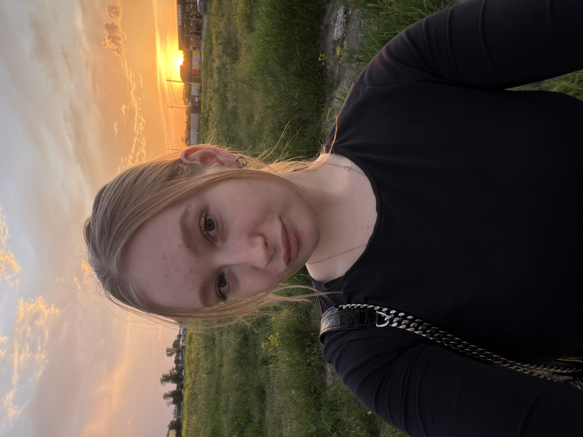 Woman takes sunset selfie in Krasnodar field