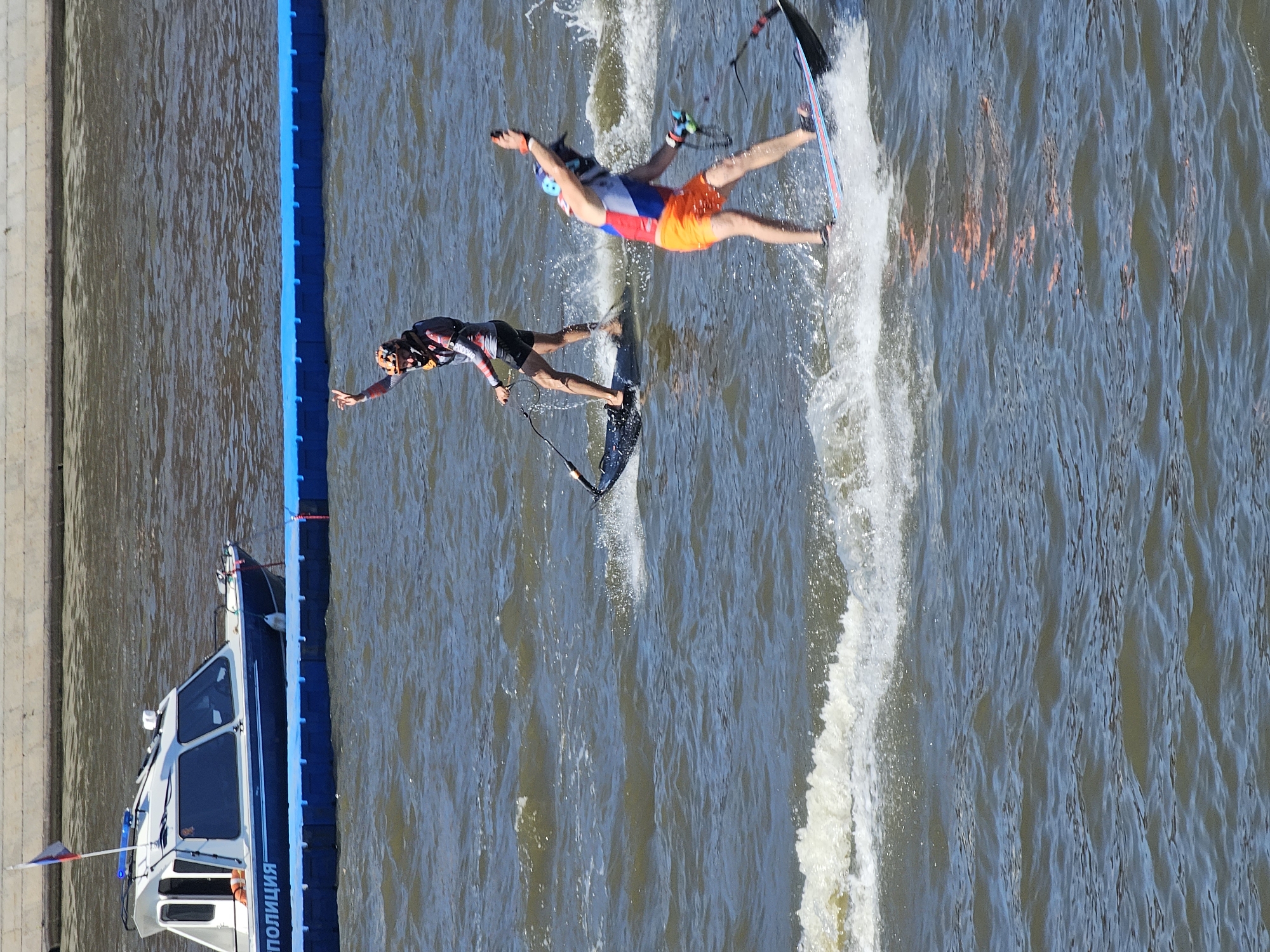 Multiple water sports disciplines going off near a city waterfront