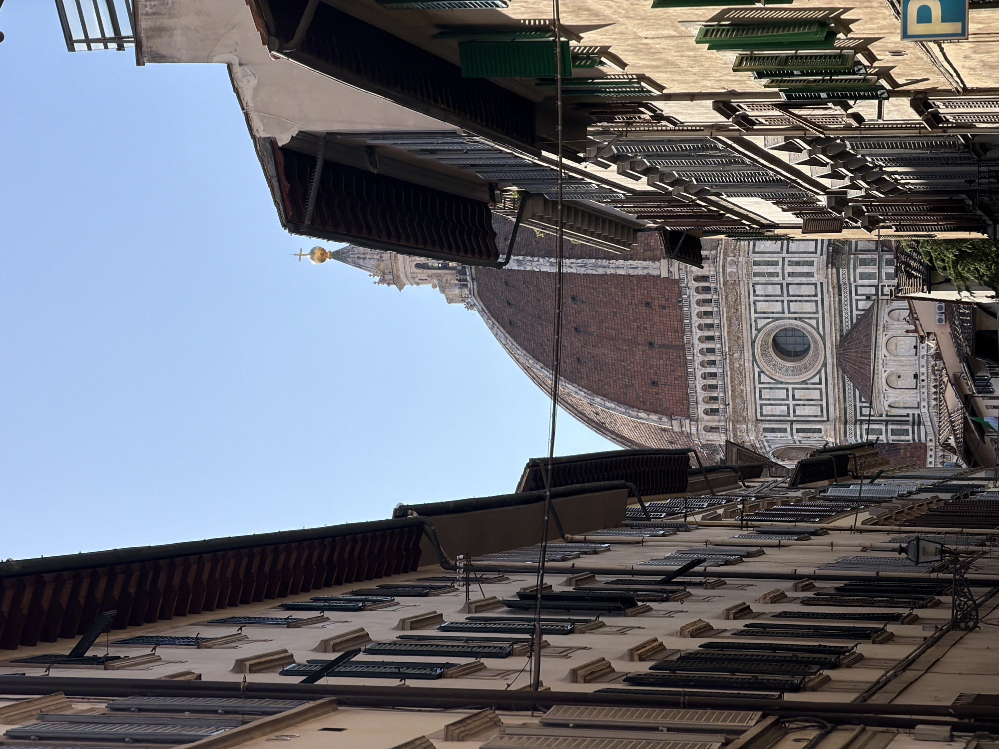 Street-level views captured of Florence Cathedral amid traditional architecture