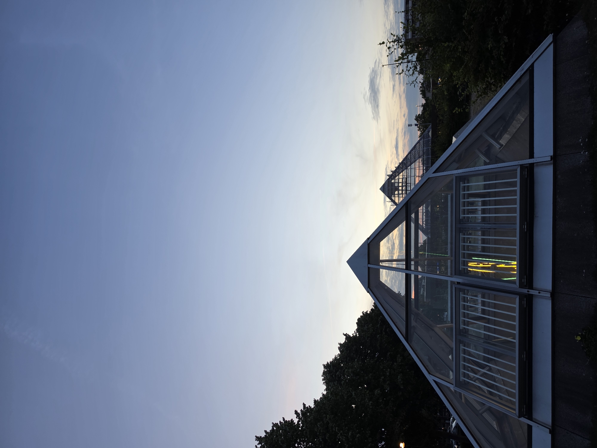 Glass pyramids and modern architecture glow at dusk in Rijswijk