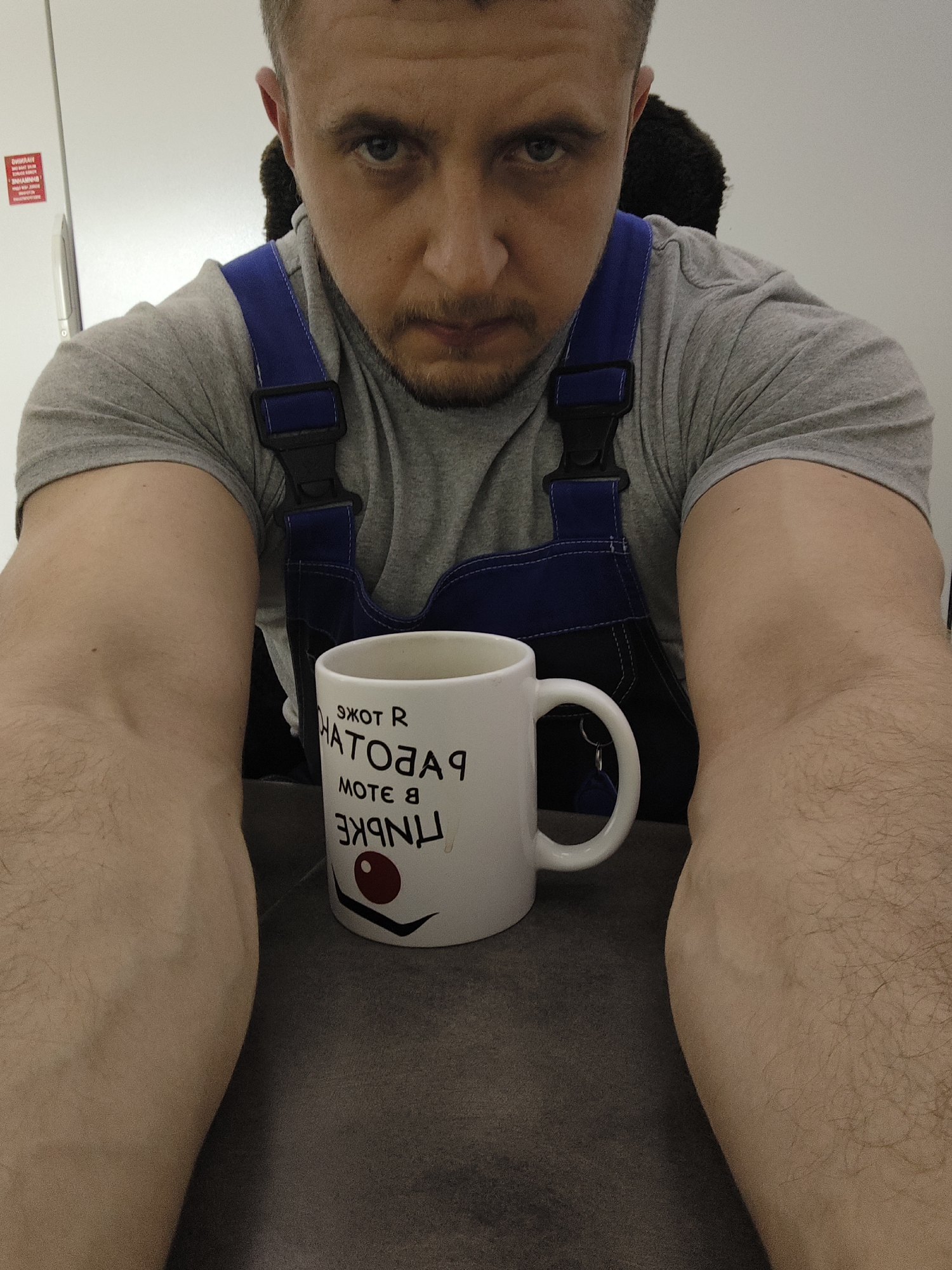 Man in overalls photographed with computer mouse, morning session