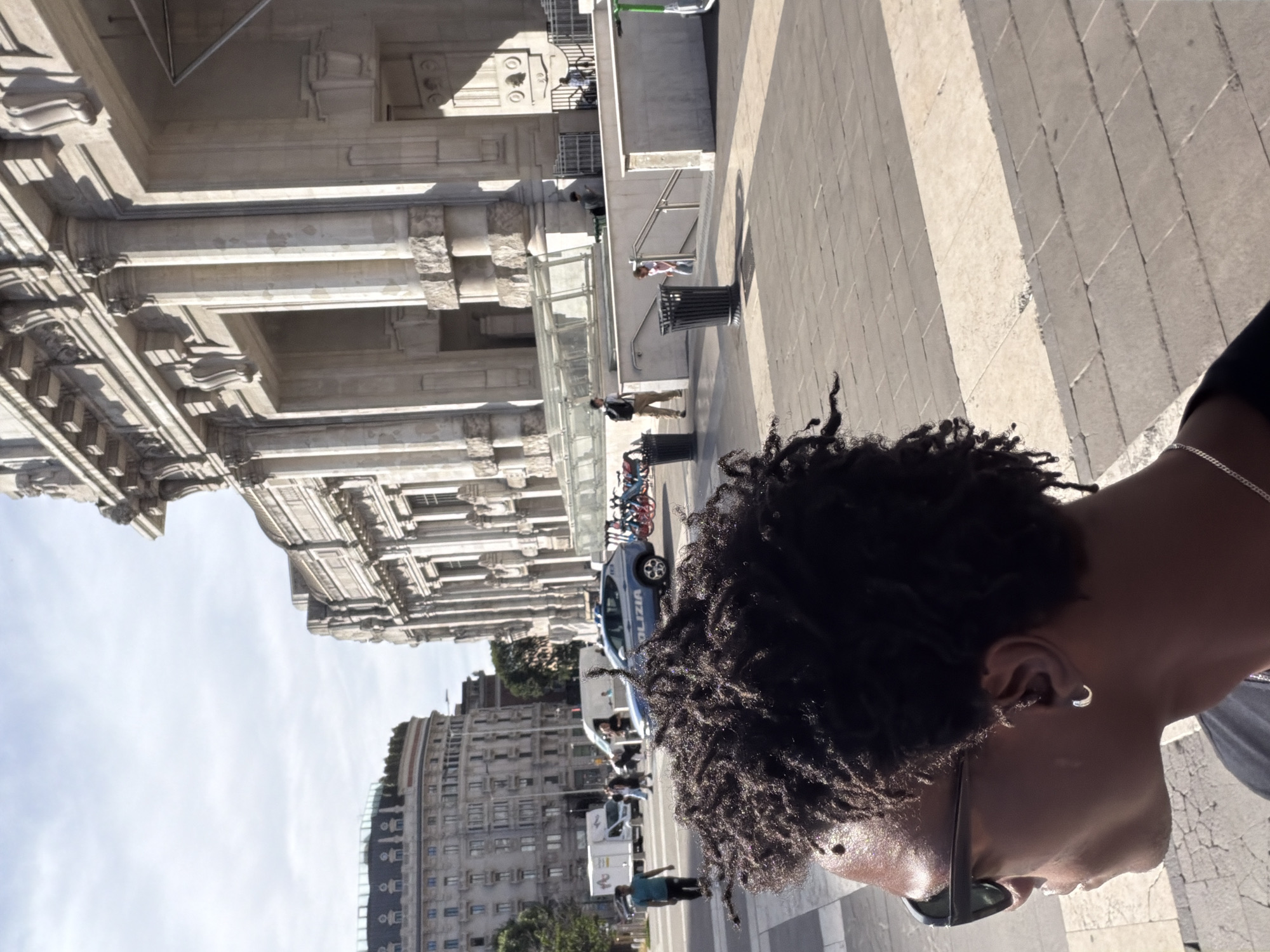 Moving through Milan — plaza, platform, and a train pulling in
