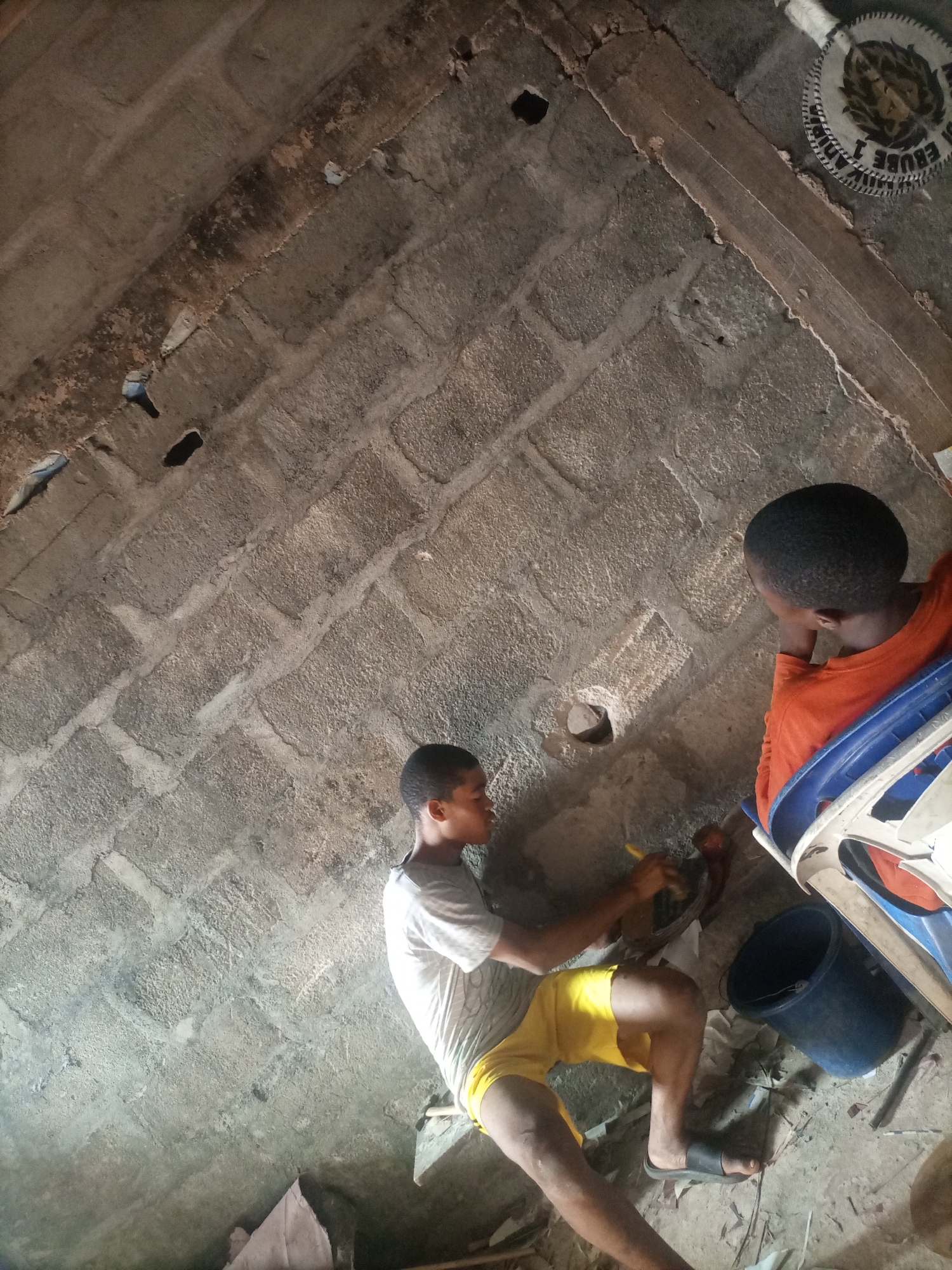 Kids doing crafts in an unfinished building, one morning