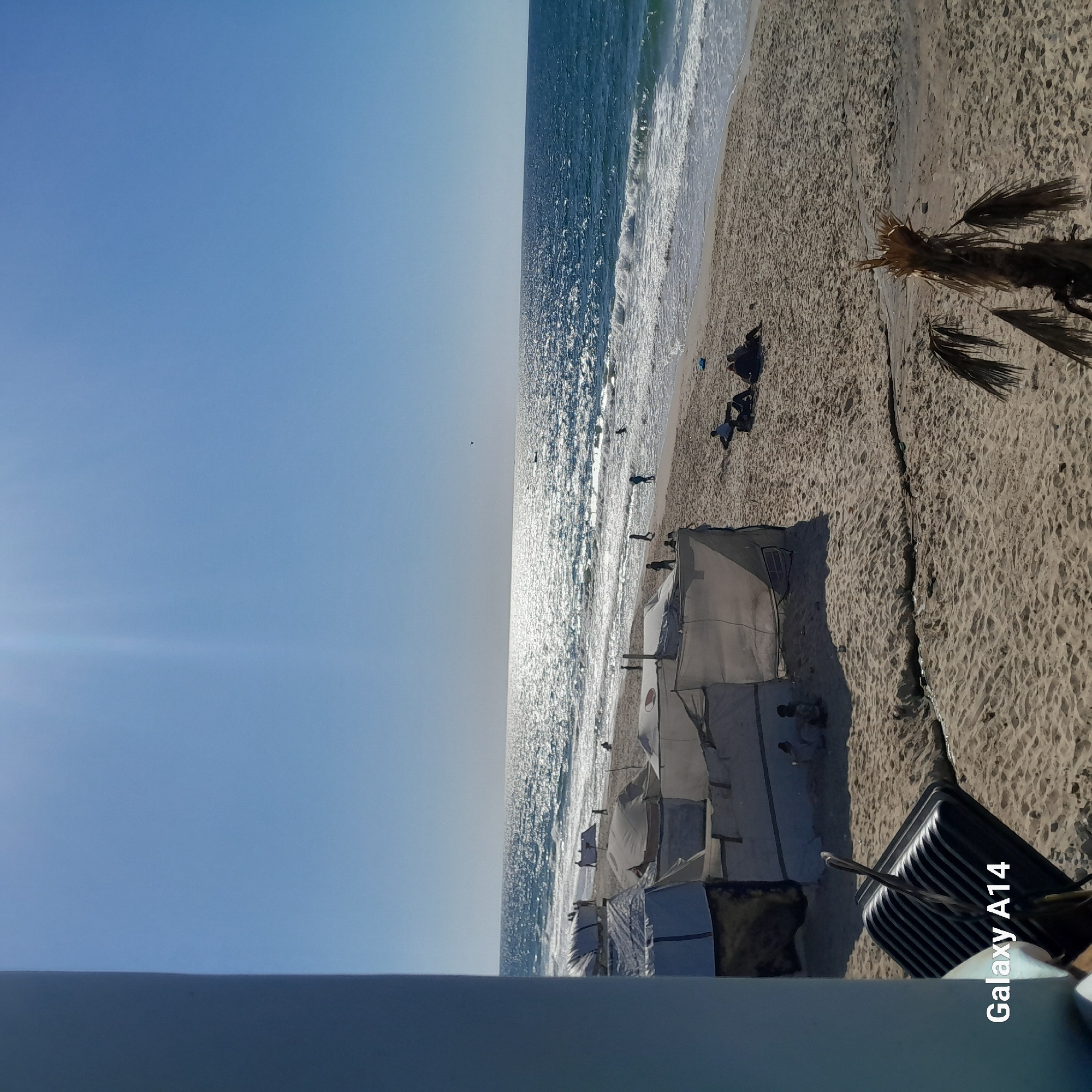 Beach scenes captured showing clear skies, waves, tents