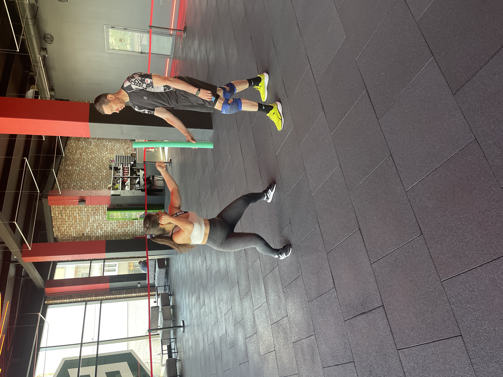 Partner workout session in an industrial-style gym
