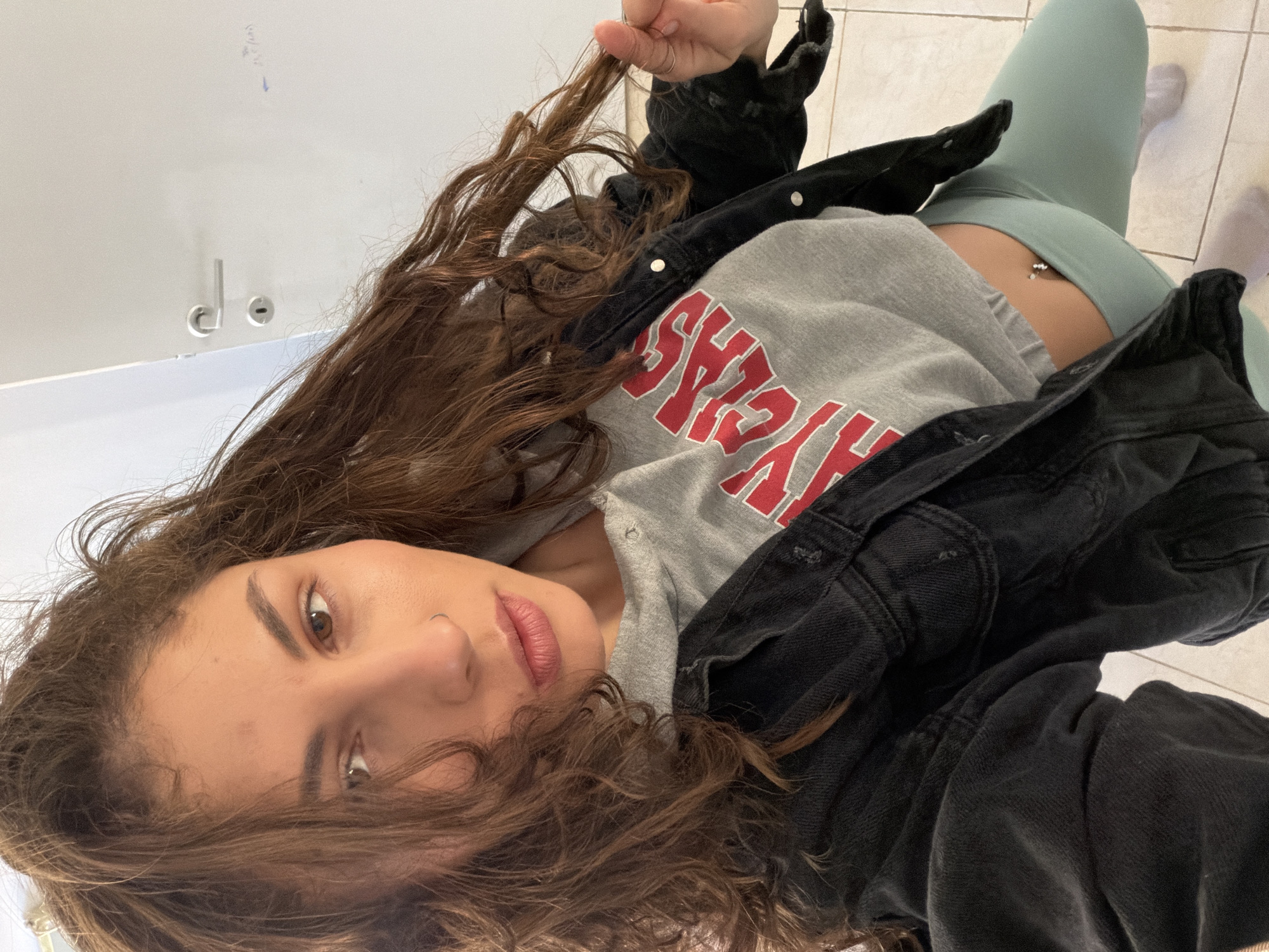 Woman takes mirror selfies in Kiryat Bialik apartment