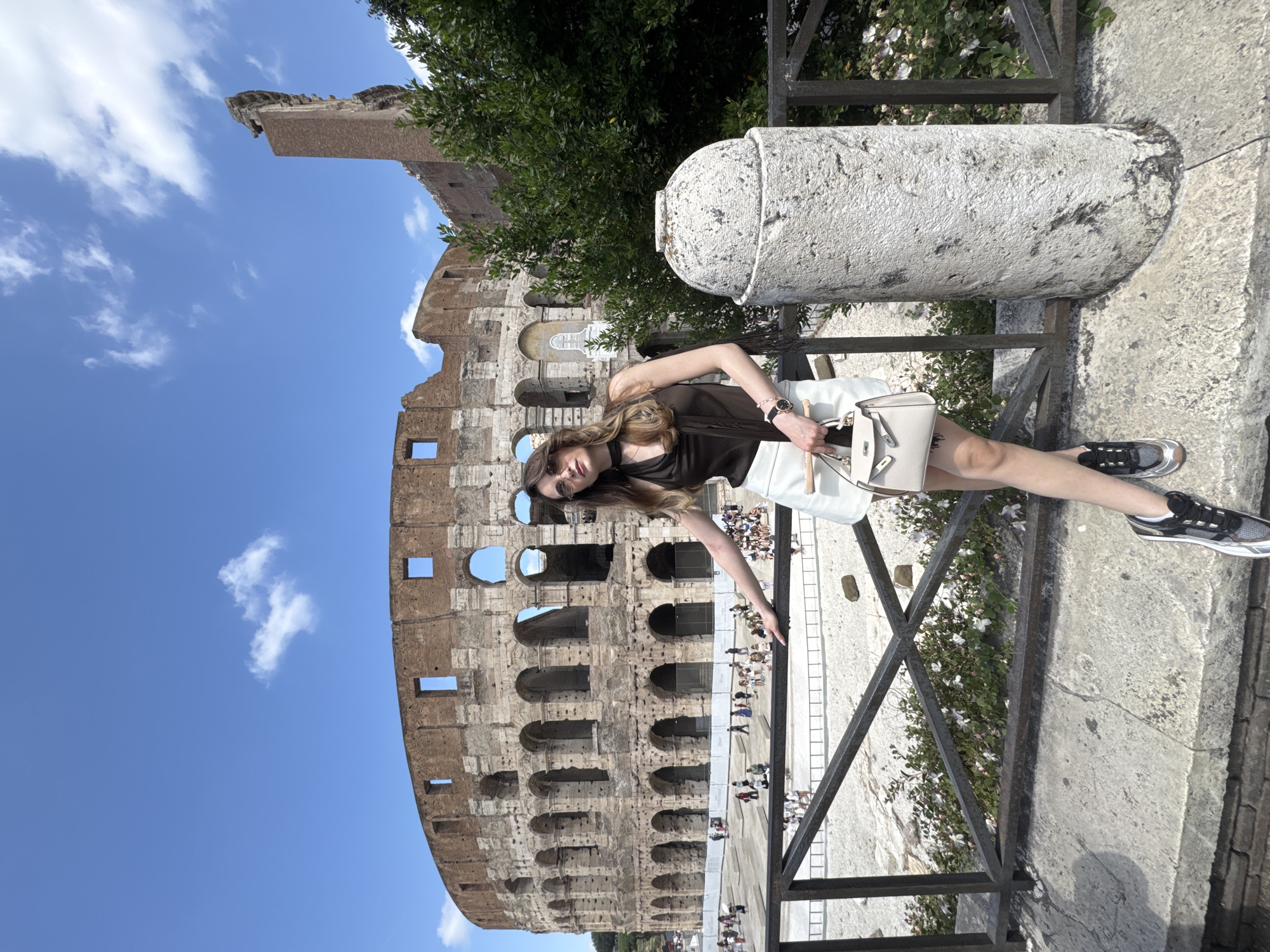 Tourist photographed at Rome's Colosseum during morning visit