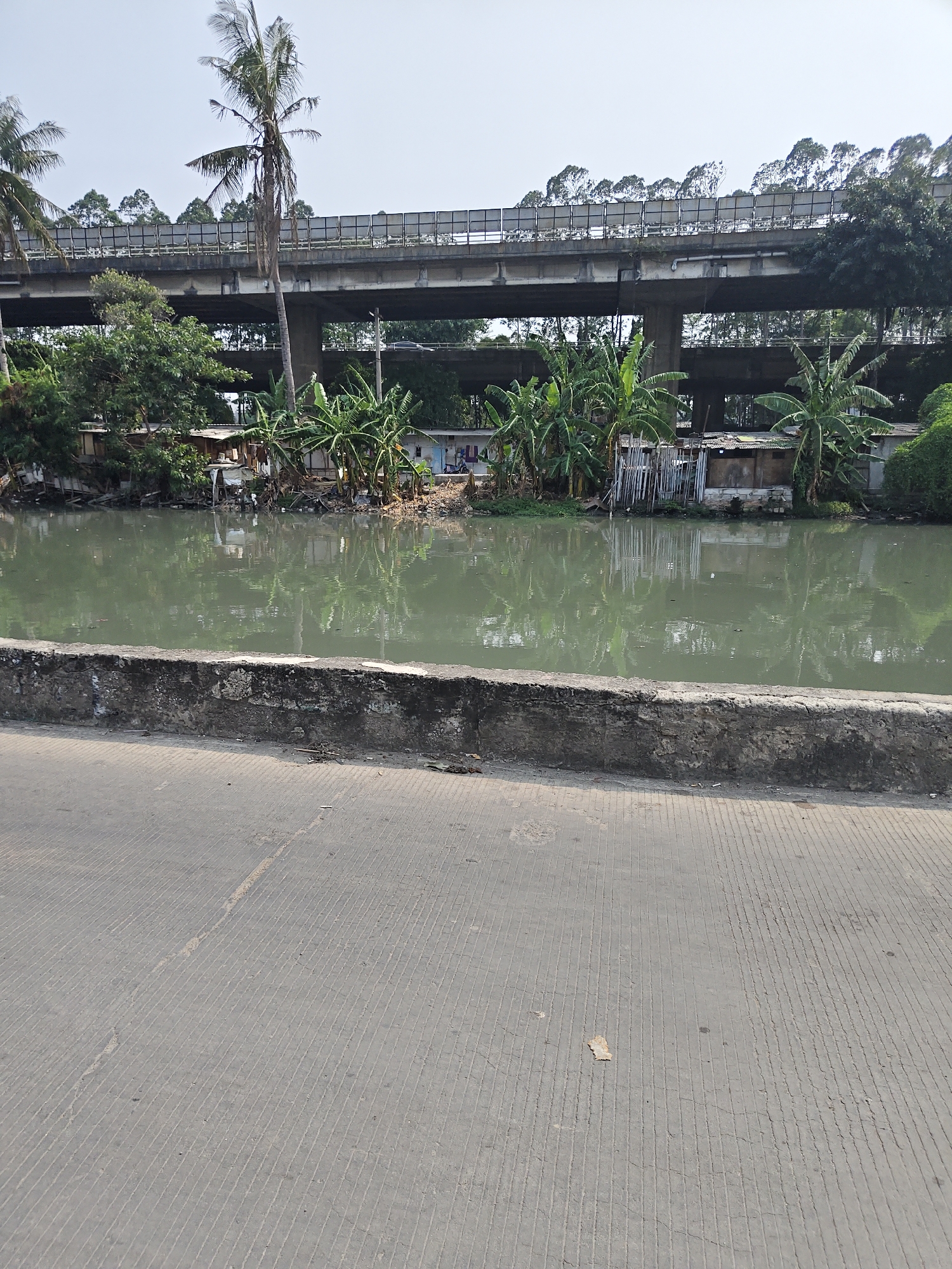 Morning motorcycle ride through North Jakarta's canal streets