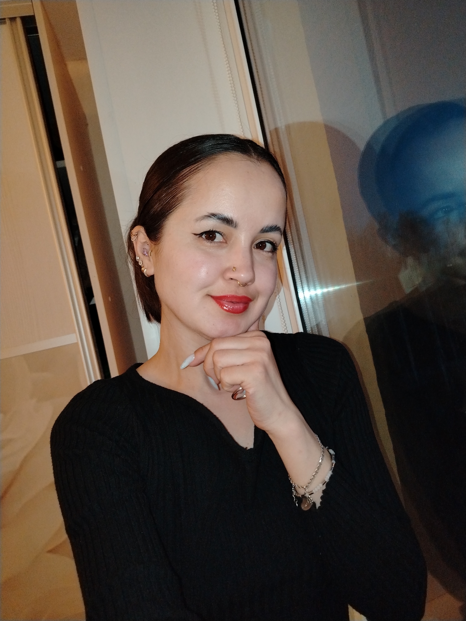 Woman photographed in multiple outfits and poses in Noviy home