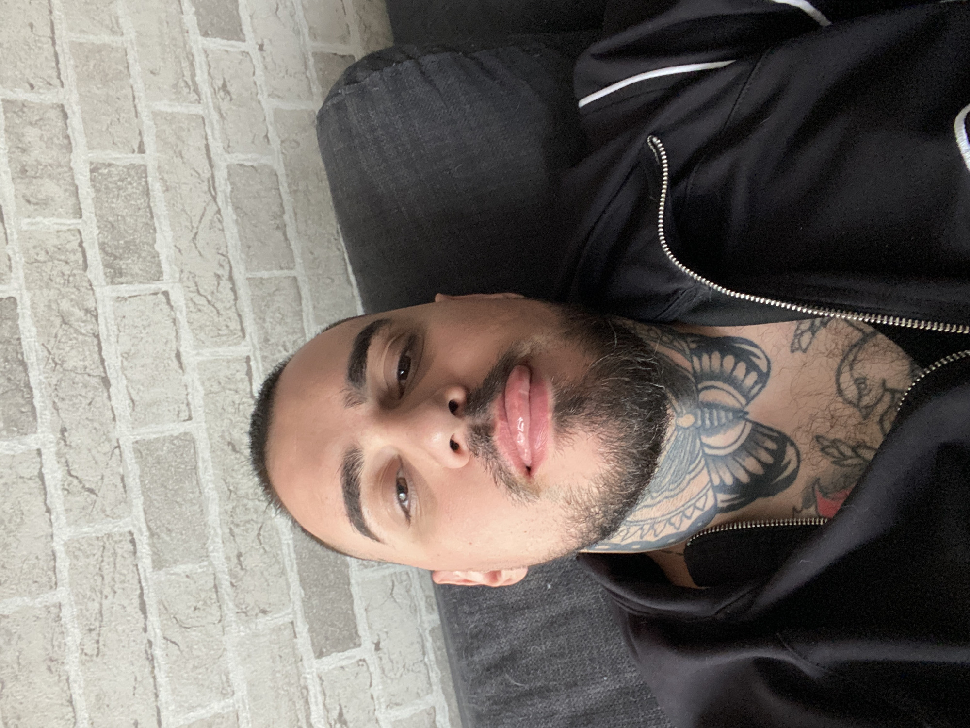 Man rests on sofa in Sofia apartment, anime plays