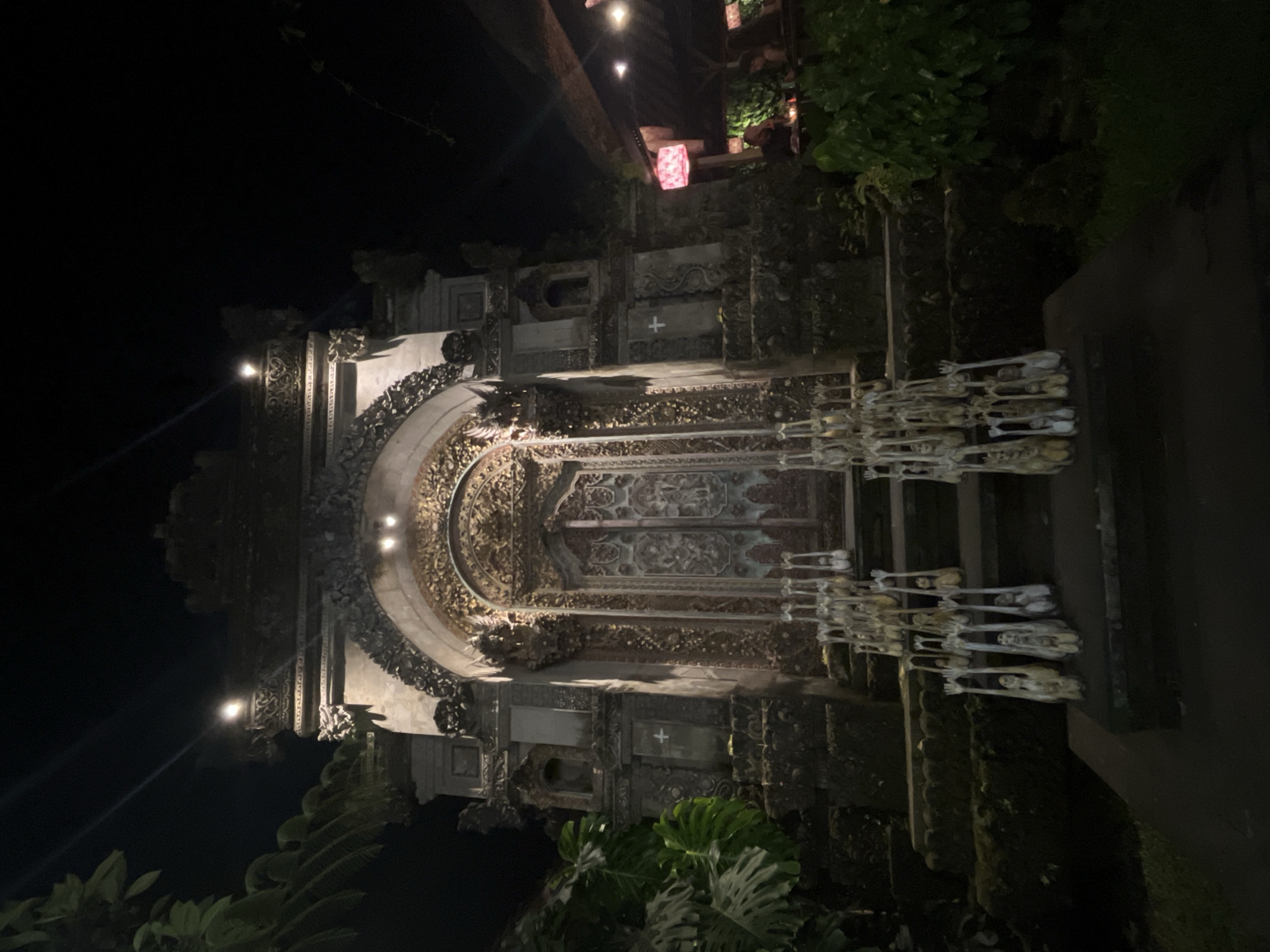 Ornate Balinese temple entrance glowing under night lights