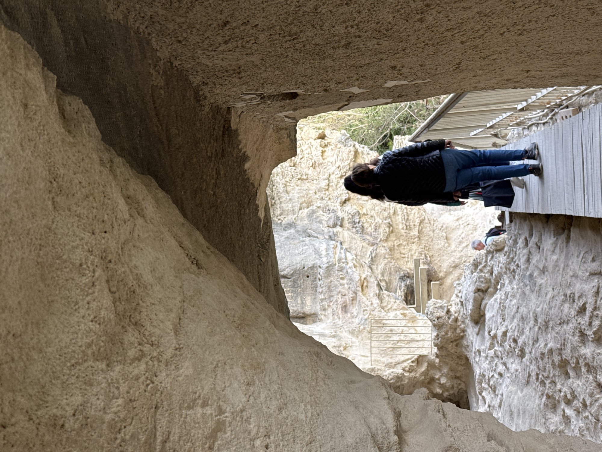 Visitor documents ancient rock formations at Aladzha Monastery, Bulgaria