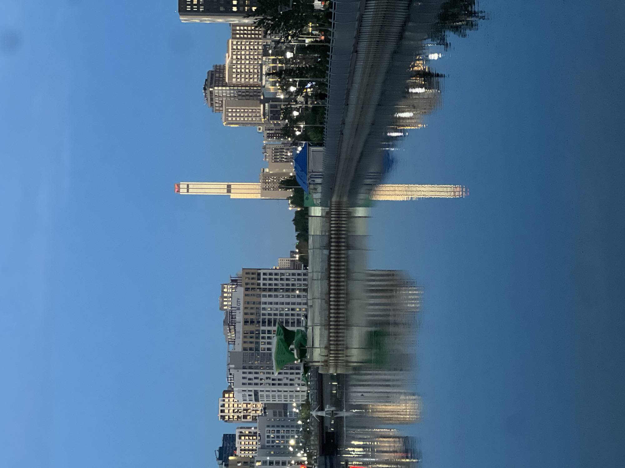 Evening fishing and cityscape reflections along Astana's Ishim River