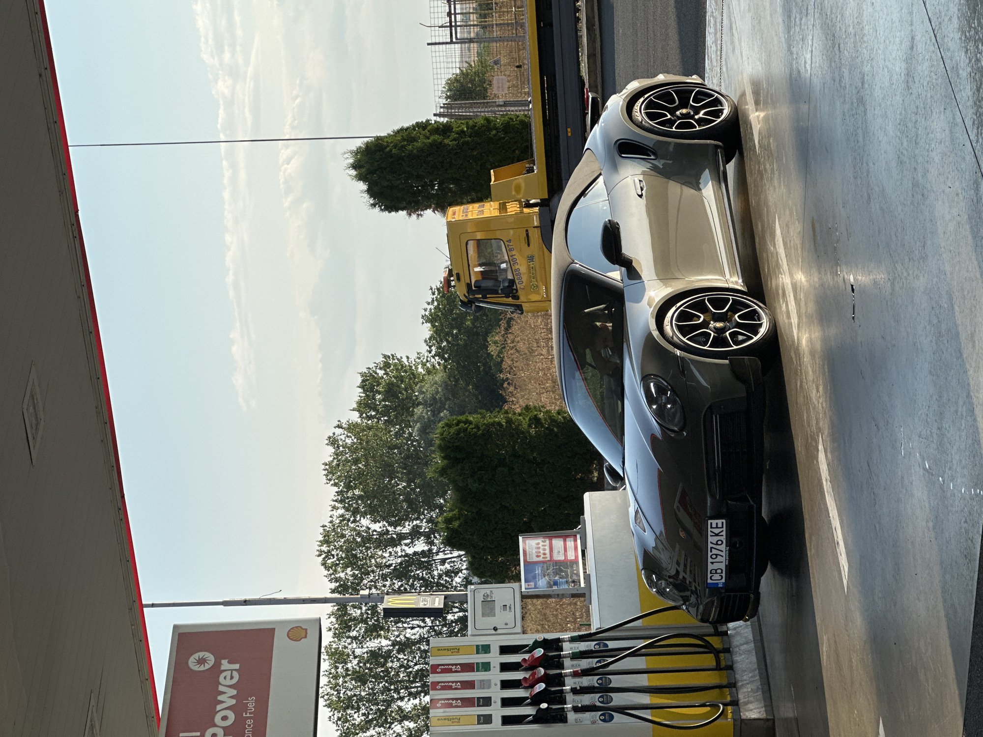 Porsche 911 convertible fueling up at Shell station in Drazhevo