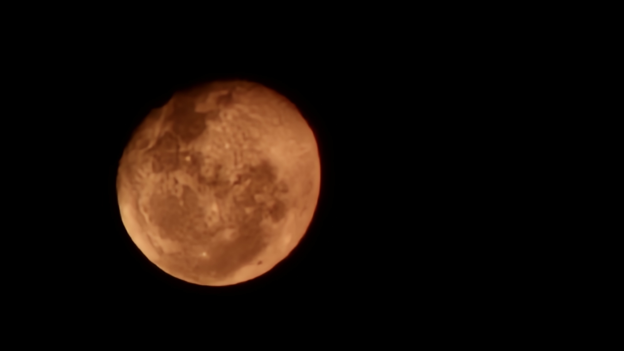 Orange full moon rising over Krasnodar, craters clearly visible