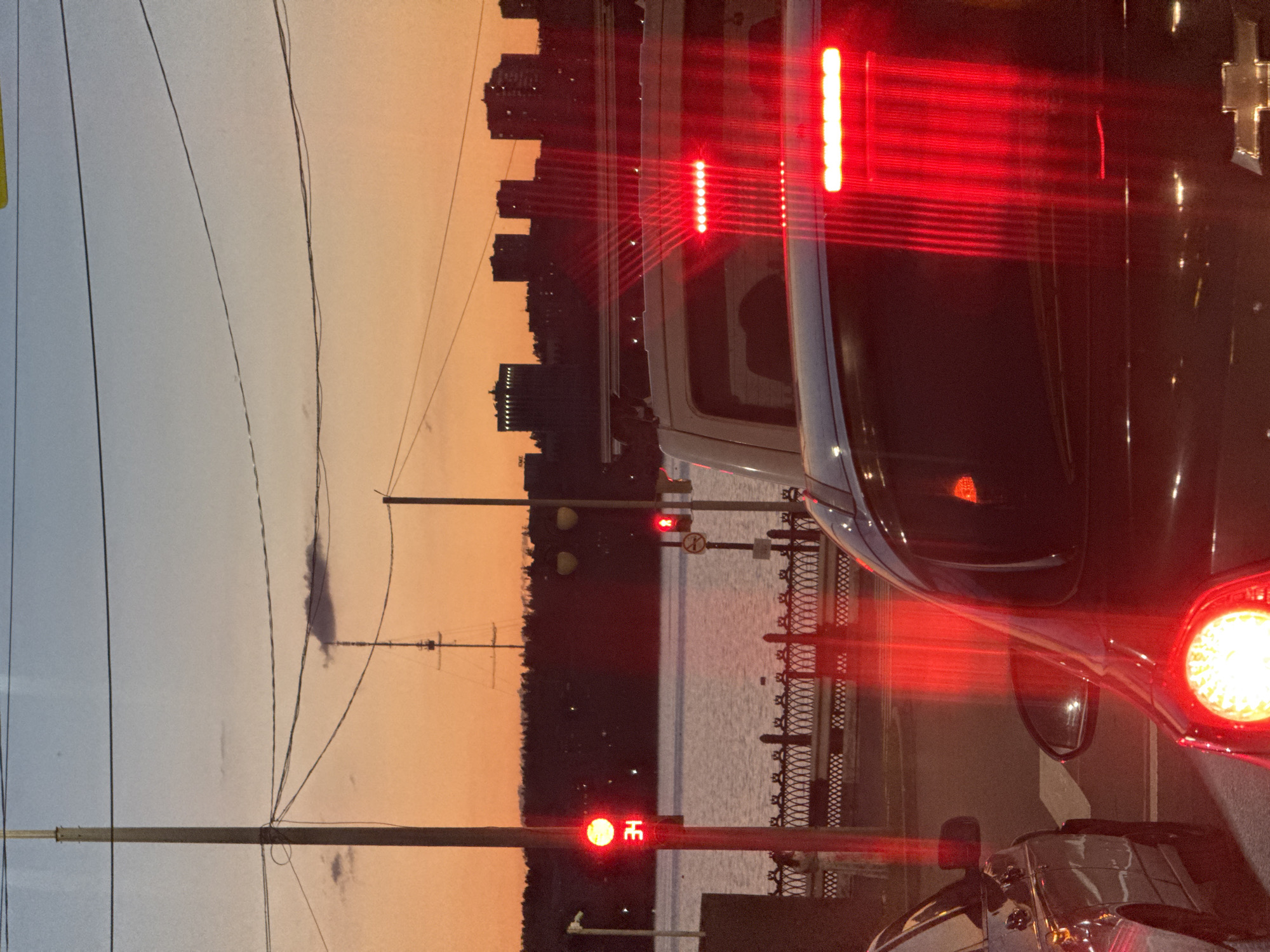 Rush hour pause at a riverside intersection in Izhevsk at dusk