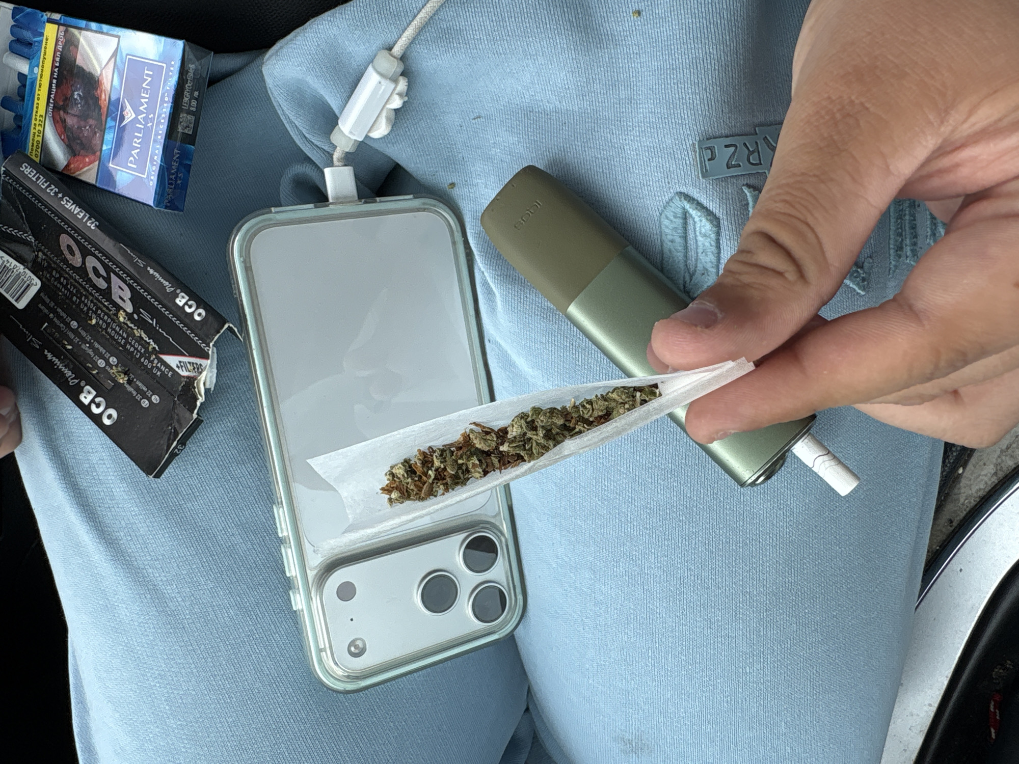 Cannabis rolling and car passenger observed at same location