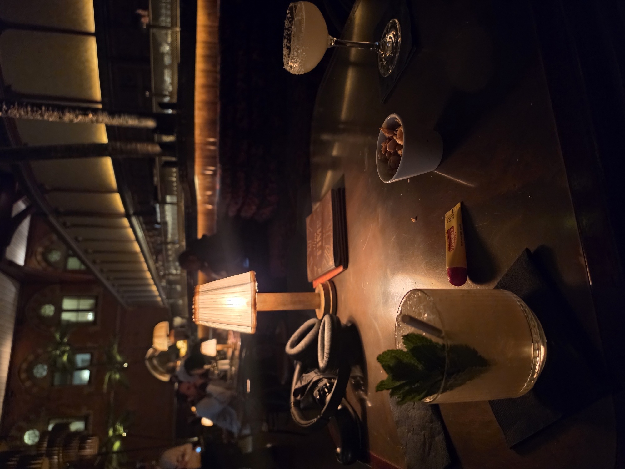 Saxophonist performs at London bar with cocktail service