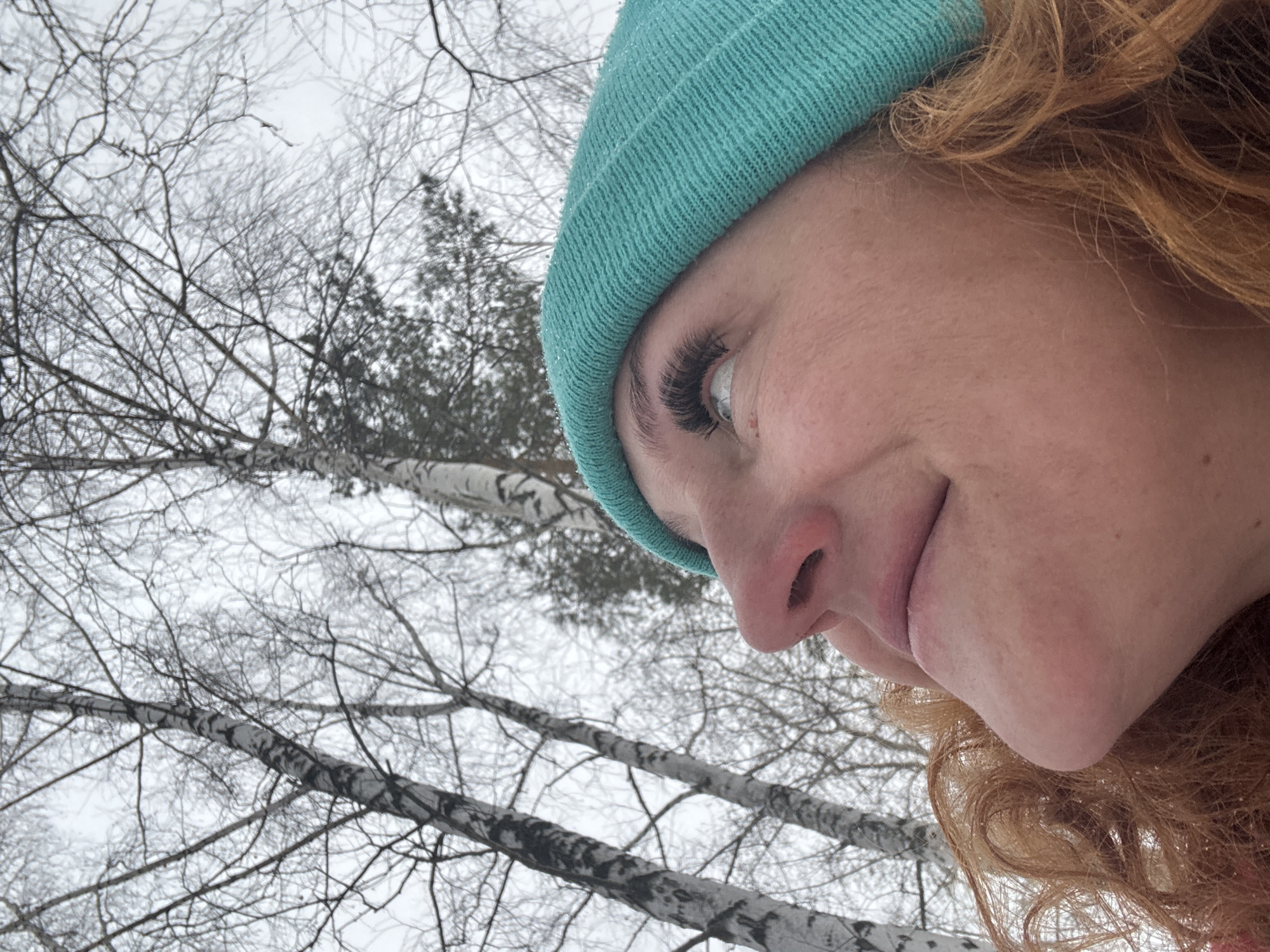 Woman plays with boxer dog in snowy Russian forest