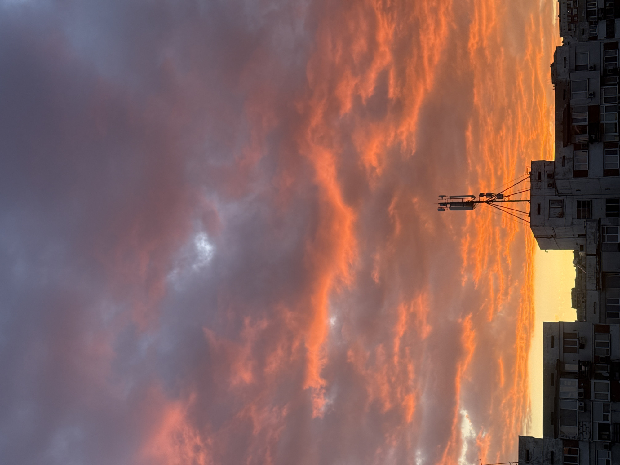 Dramatic sunset illuminates Sofia skyline amid storm clouds