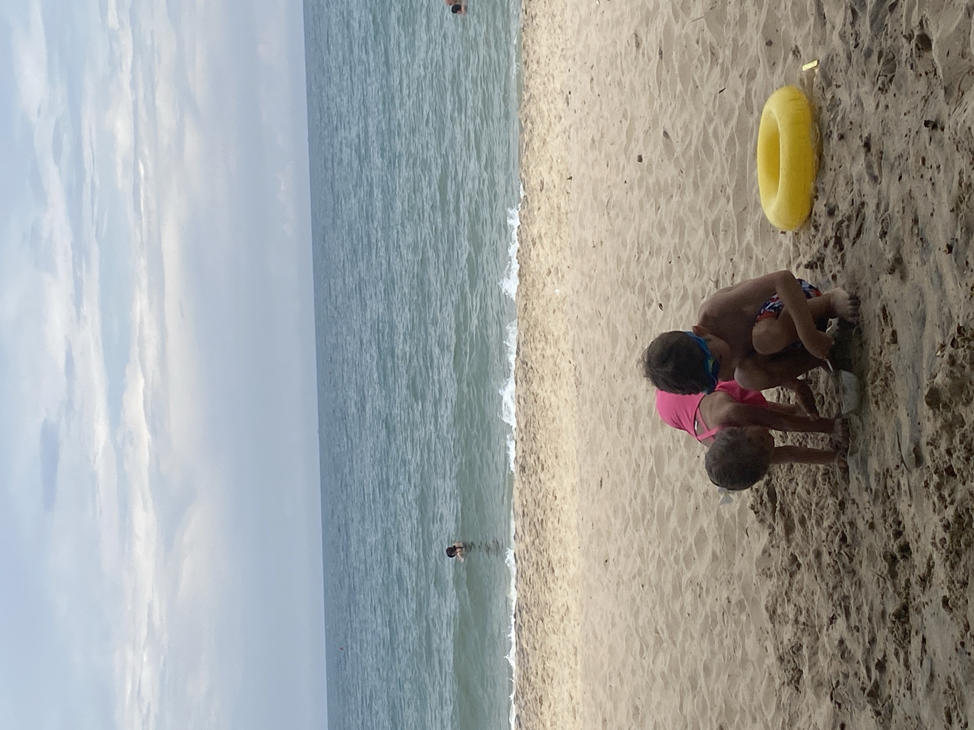 Beach day at a Vietnamese resort, kids playing, adults relaxing