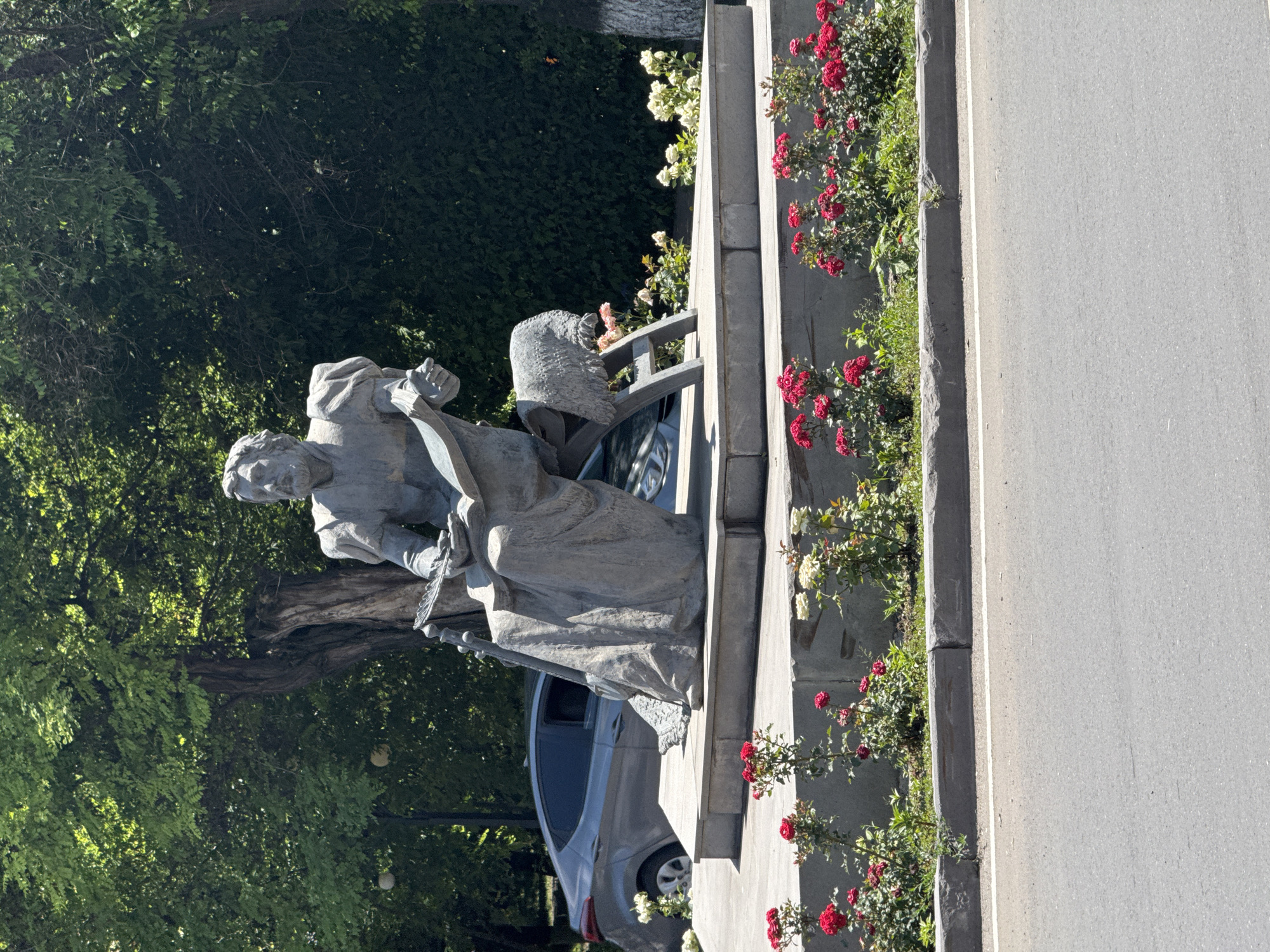 Stone monument of a robed, book-reading figure in Armenia