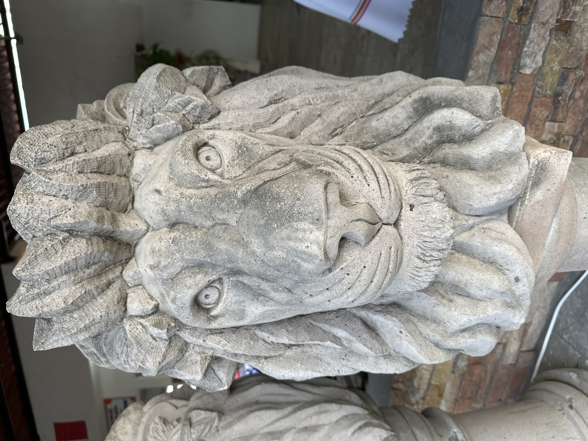 Decorative stone lion sculpture, ceramic plates documented in Mexico