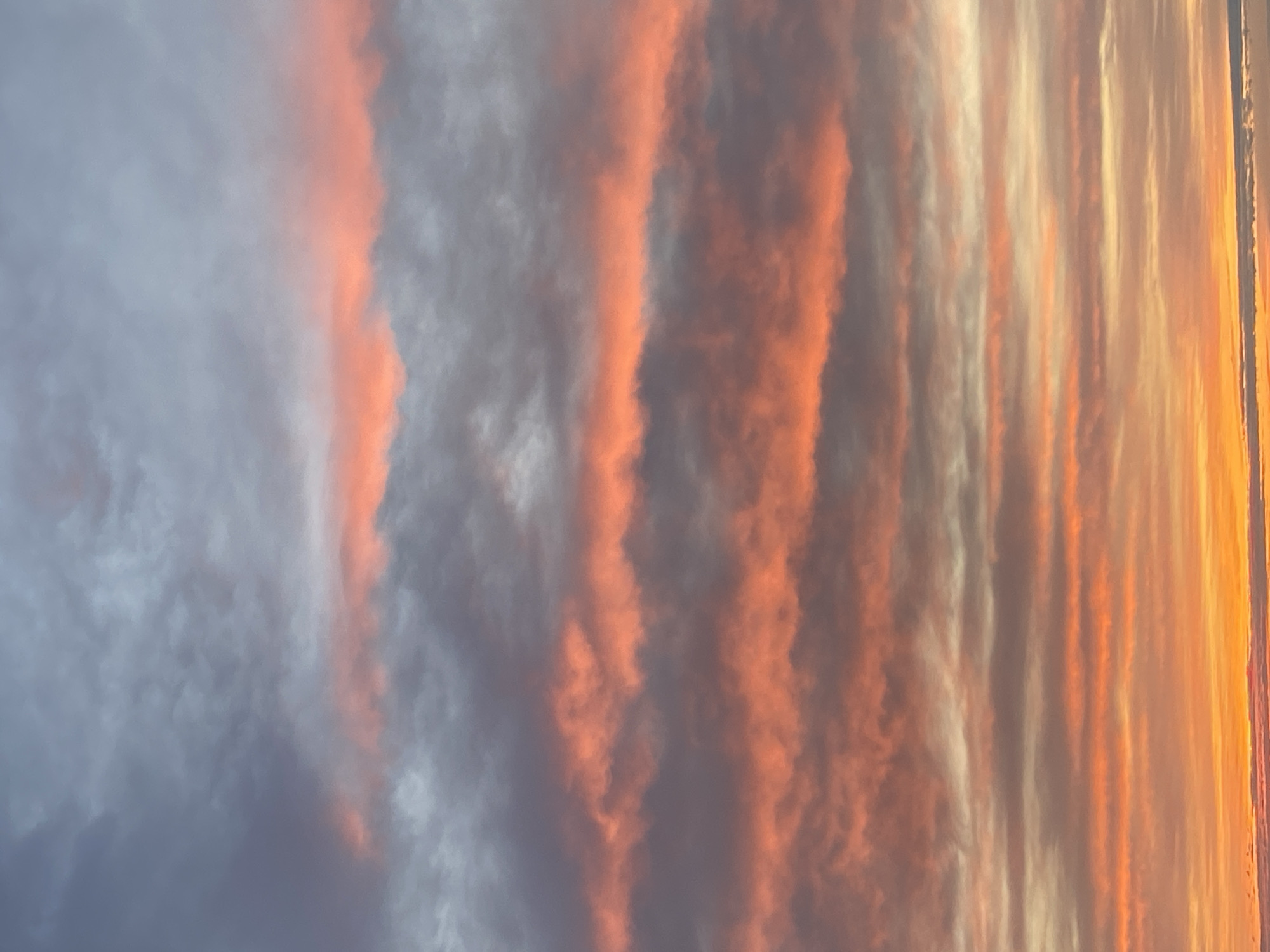 Colorful striated clouds observed during sunset in Izhevsk, Russia
