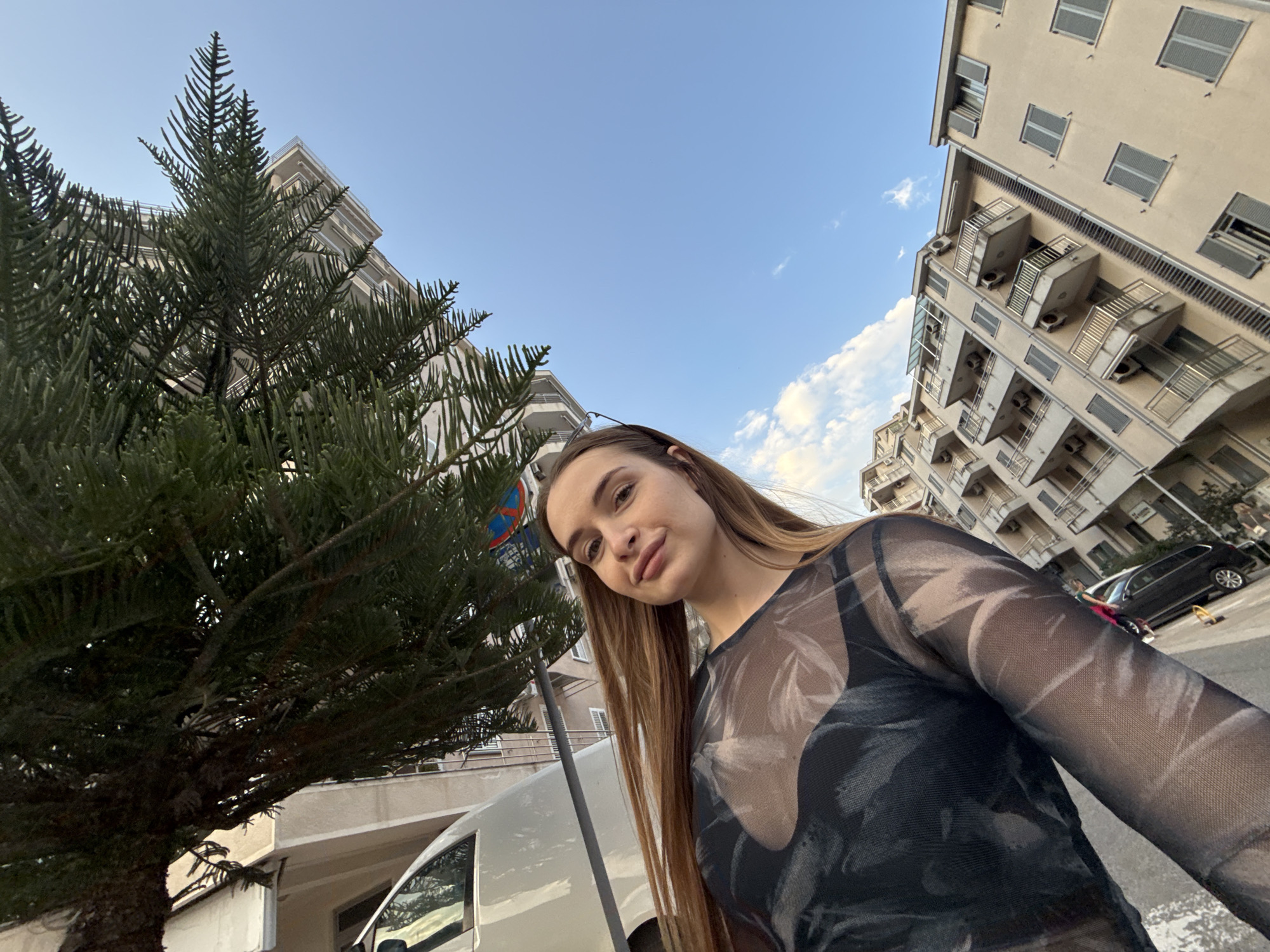 Woman takes selfie in urban Budva, Montenegro