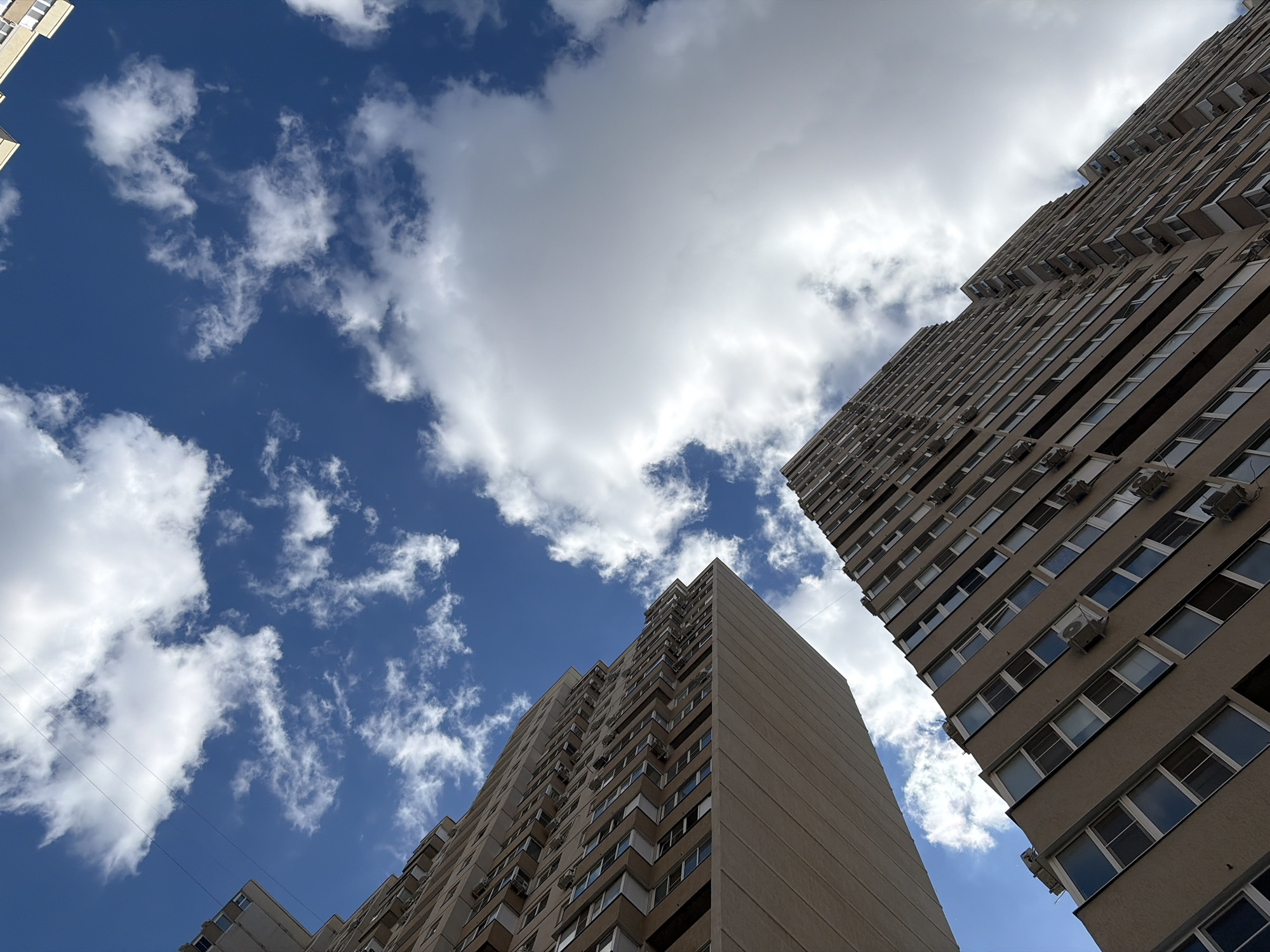 Upward view captured between residential buildings in Krasnodar
