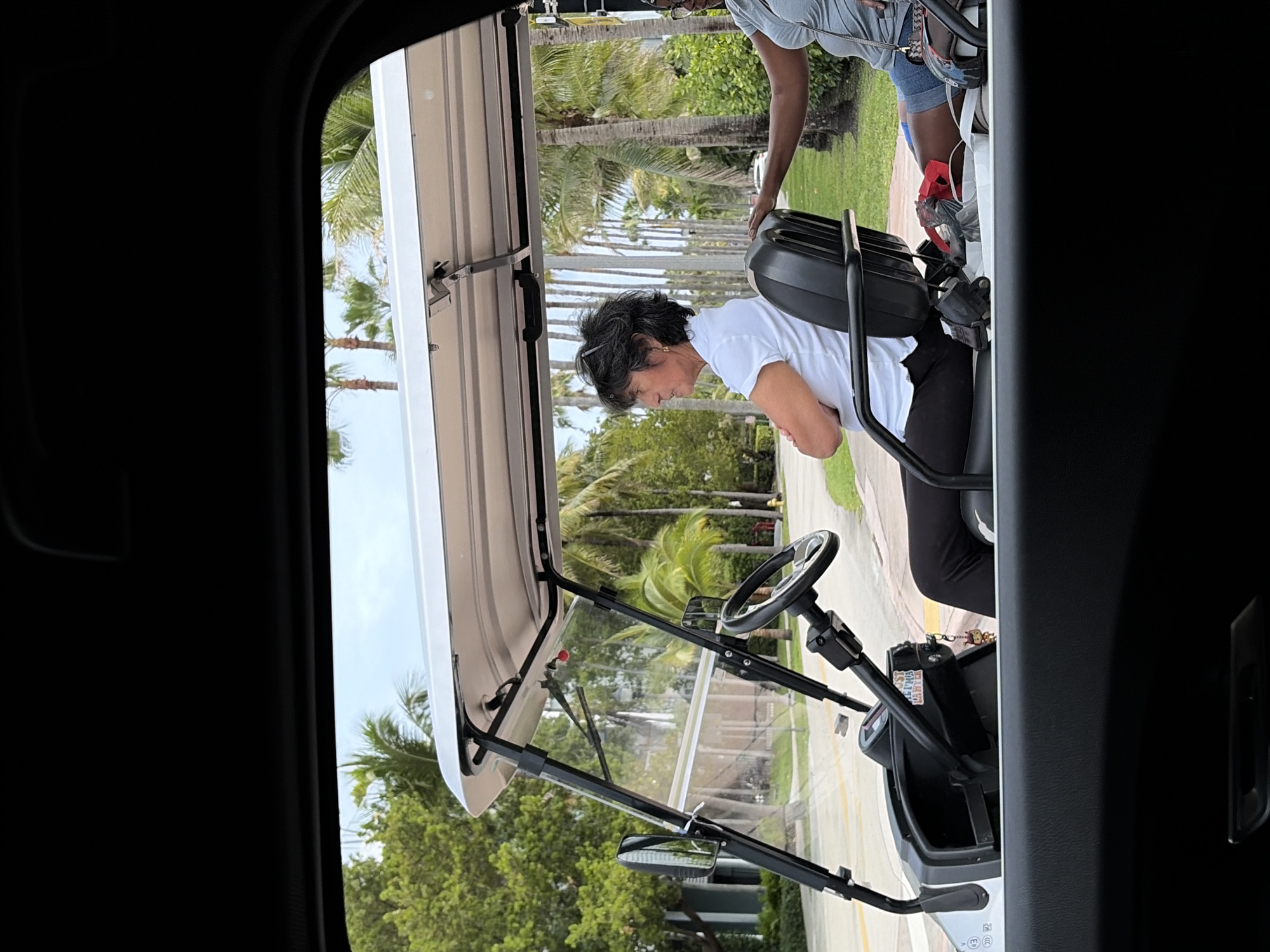Woman sits in golf cart in Key Biscayne