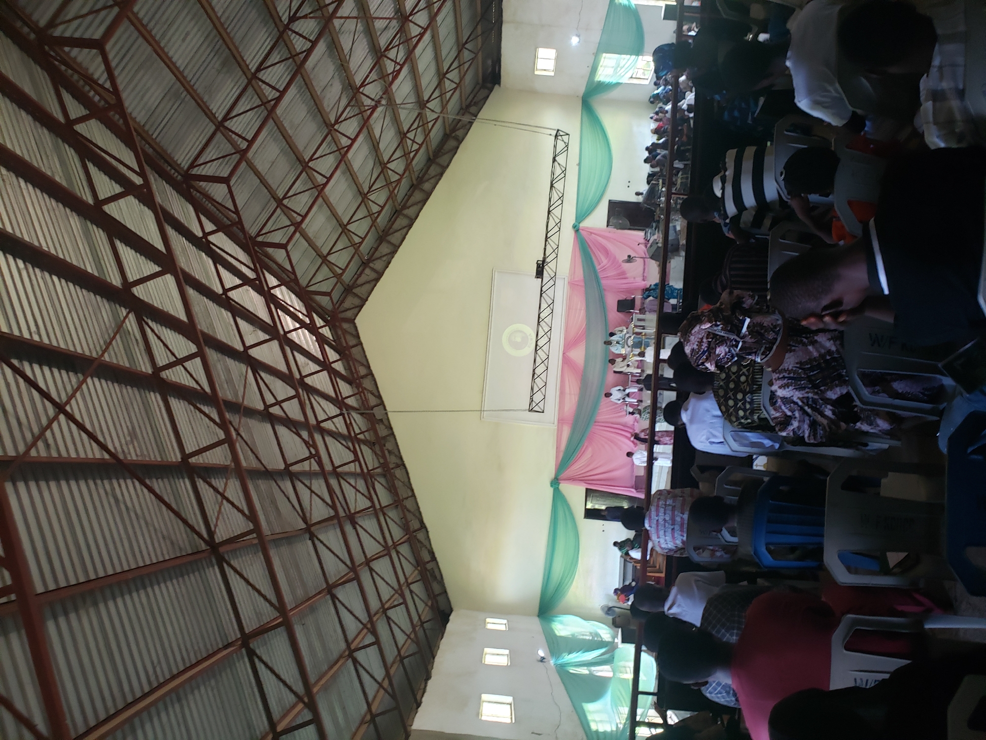 Witness documents indoor gathering and concrete building in Narayi