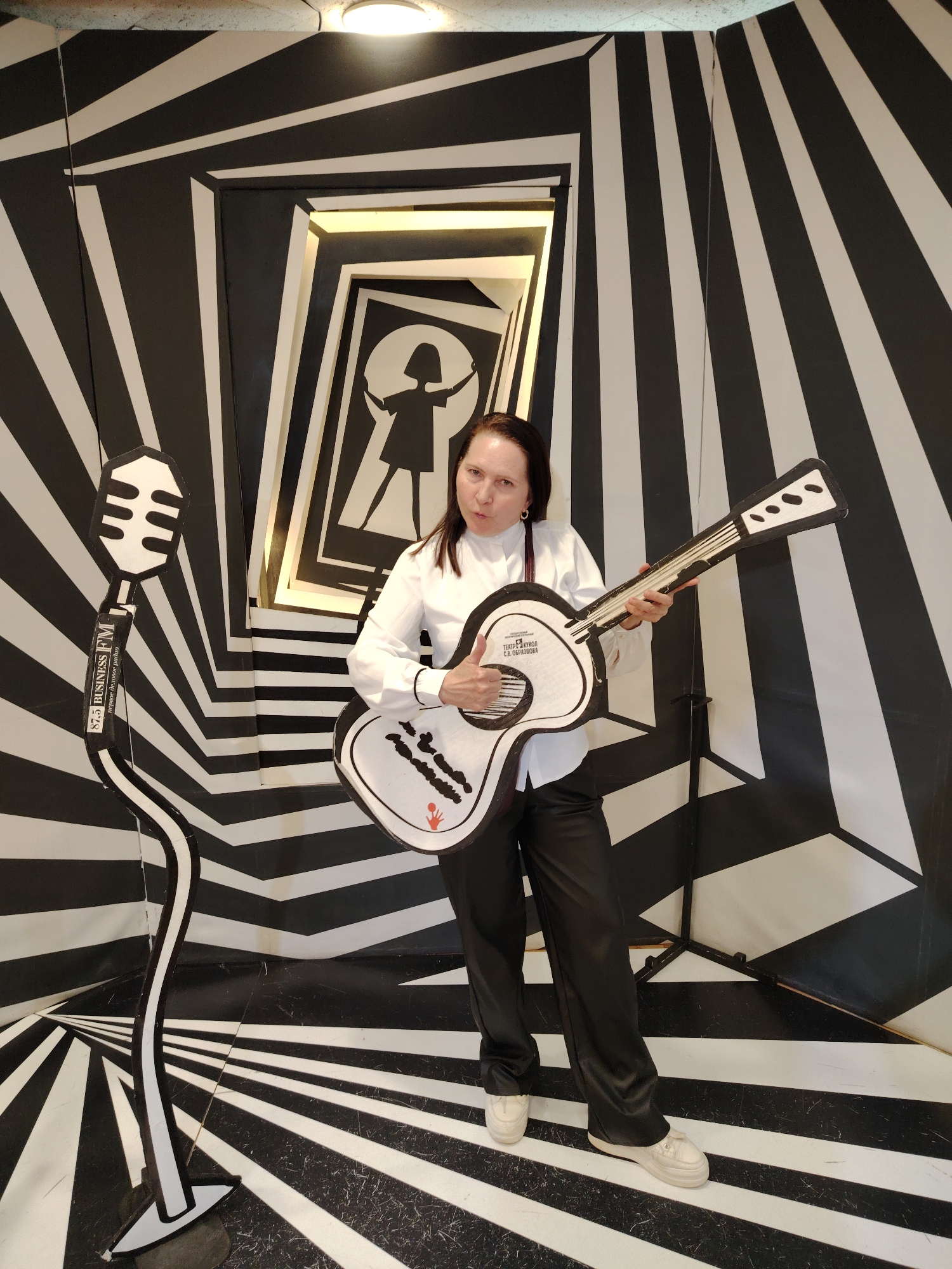 Woman poses with optical illusion backdrop in Moscow